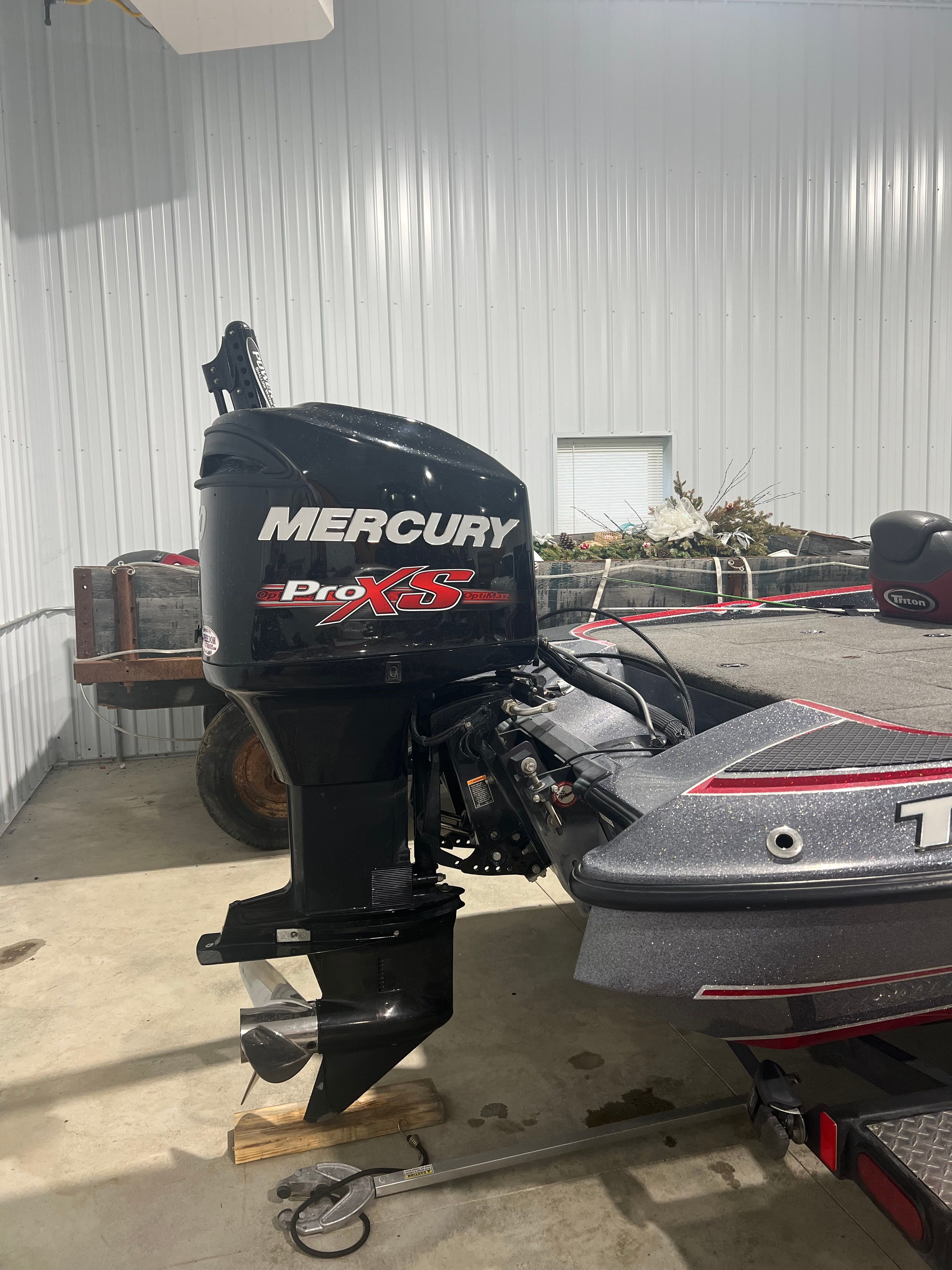 A 2015 Triton 18XS with a Mercury Pro XS outboard motor in a storage facility.