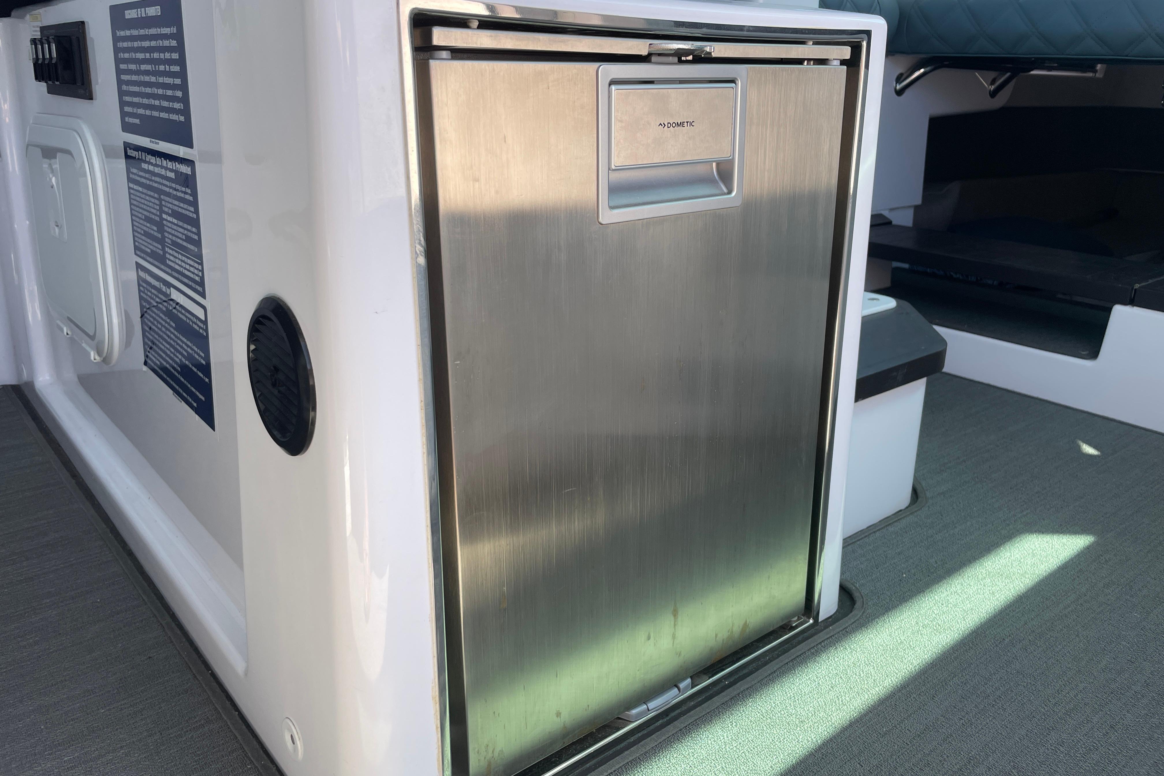 2023 Axopar 37 XC Cross Cabin interior with stainless steel fridge.