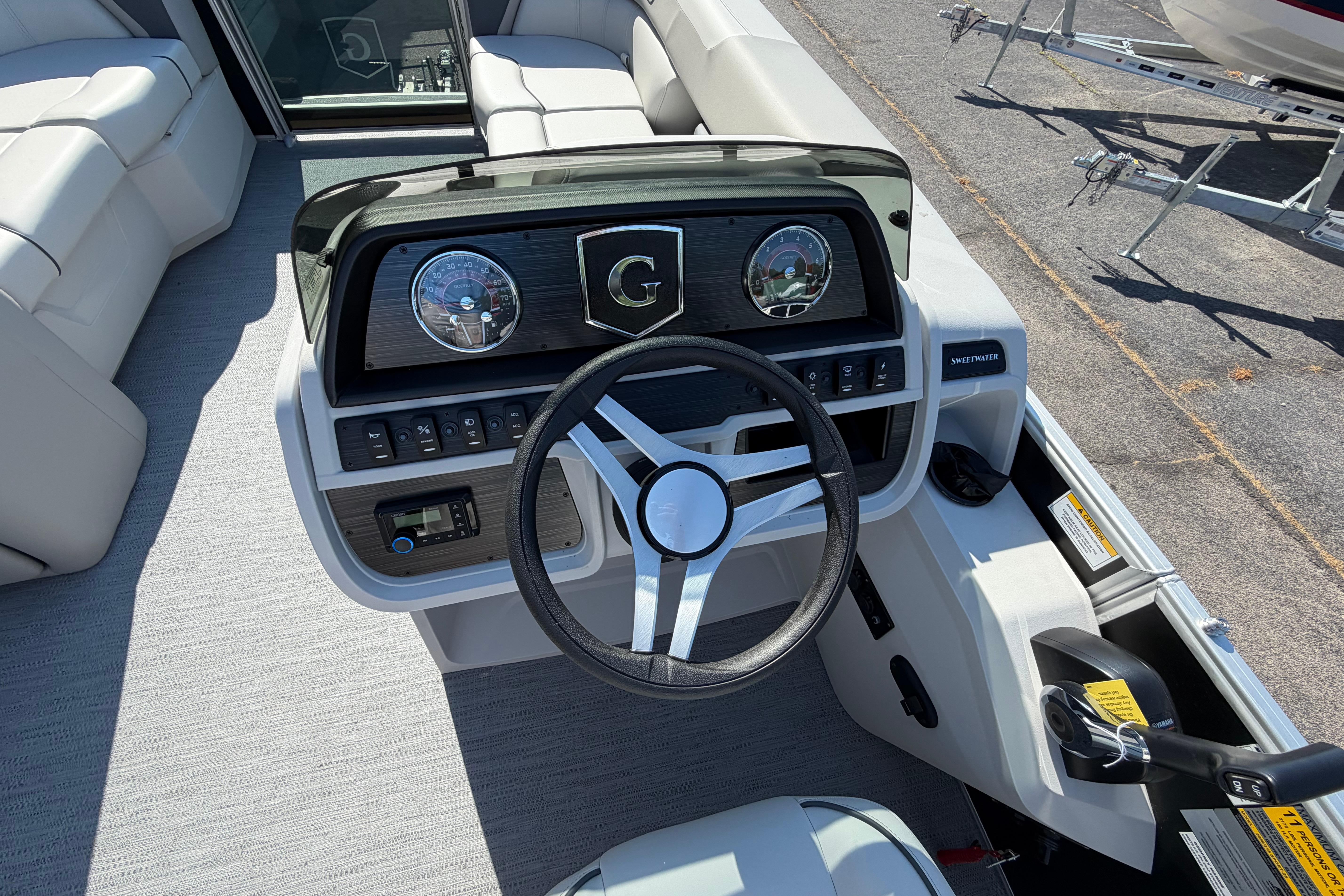 2026 Godfrey Sweetwater 2086 SBC boat dashboard with steering wheel and controls.
