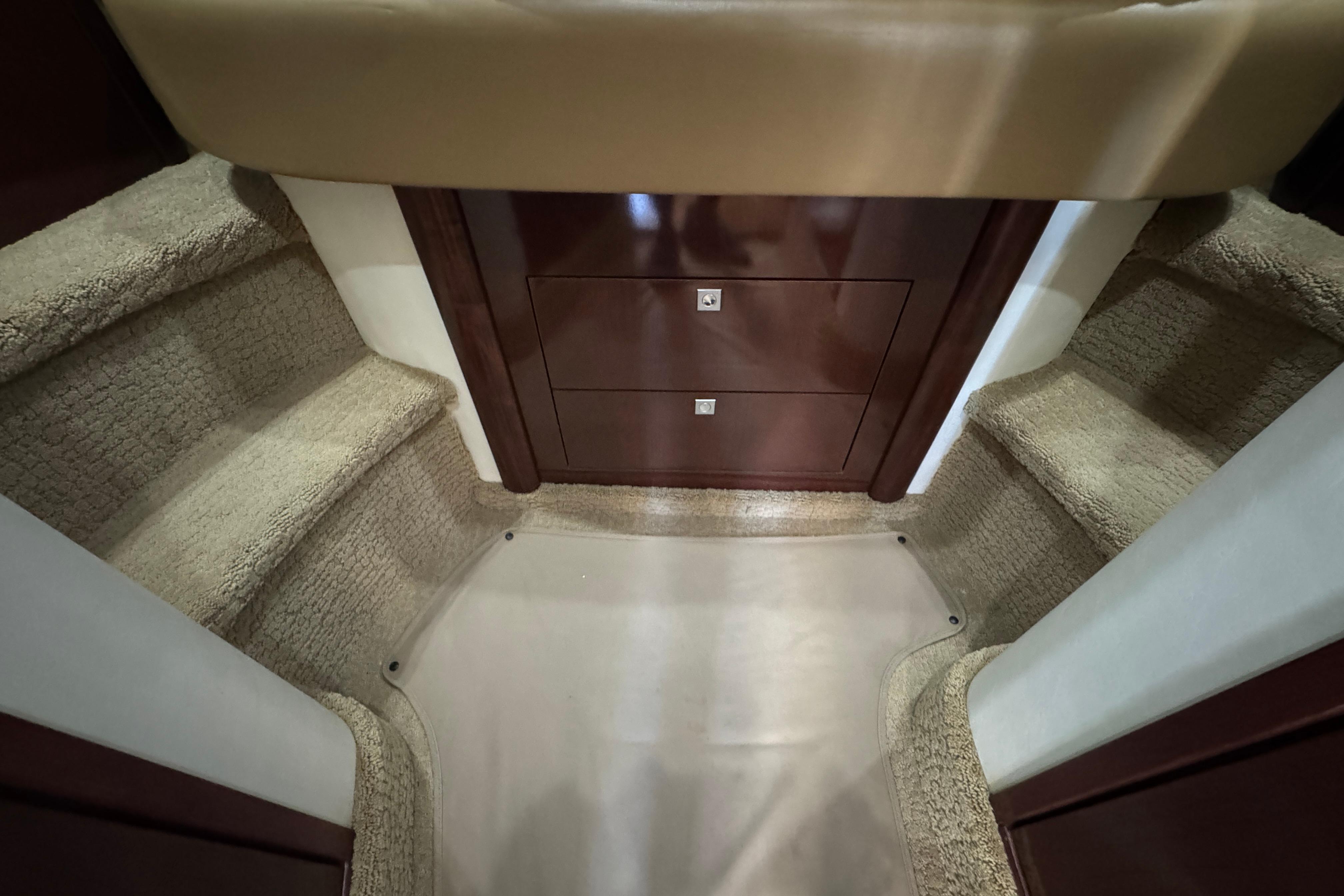 Interior stairs of 2008 Sea Ray 40 Sundancer yacht with carpeted steps and wooden cabinetry.