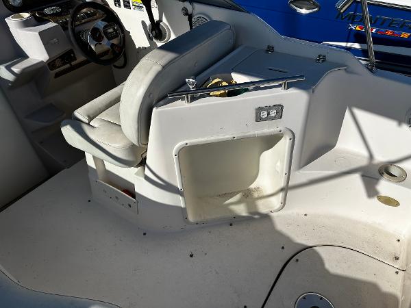 2004 Rinker Fiesta Vee 250 boat interior with seating and control panel.