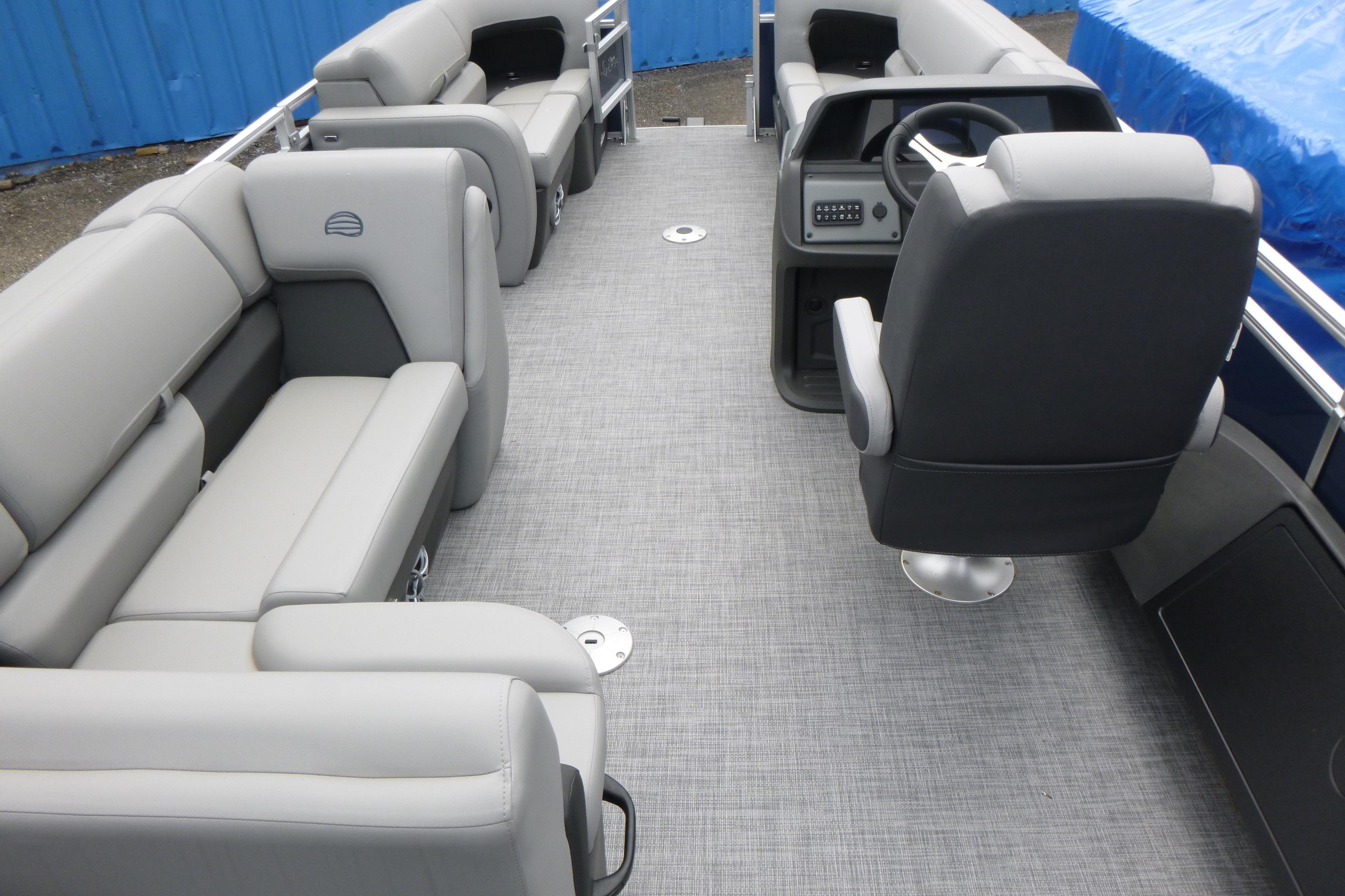 2026 Sun Tracker SportFish 22 DLX pontoon boat interior with gray seating and steering console.