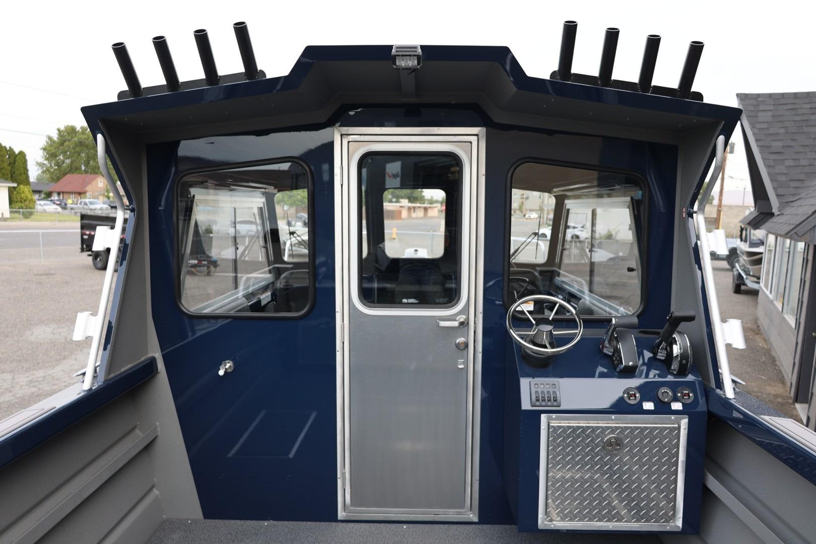 2026 Thunder Jet 24 Alexis Pro boat cockpit with steering wheel and control panel.