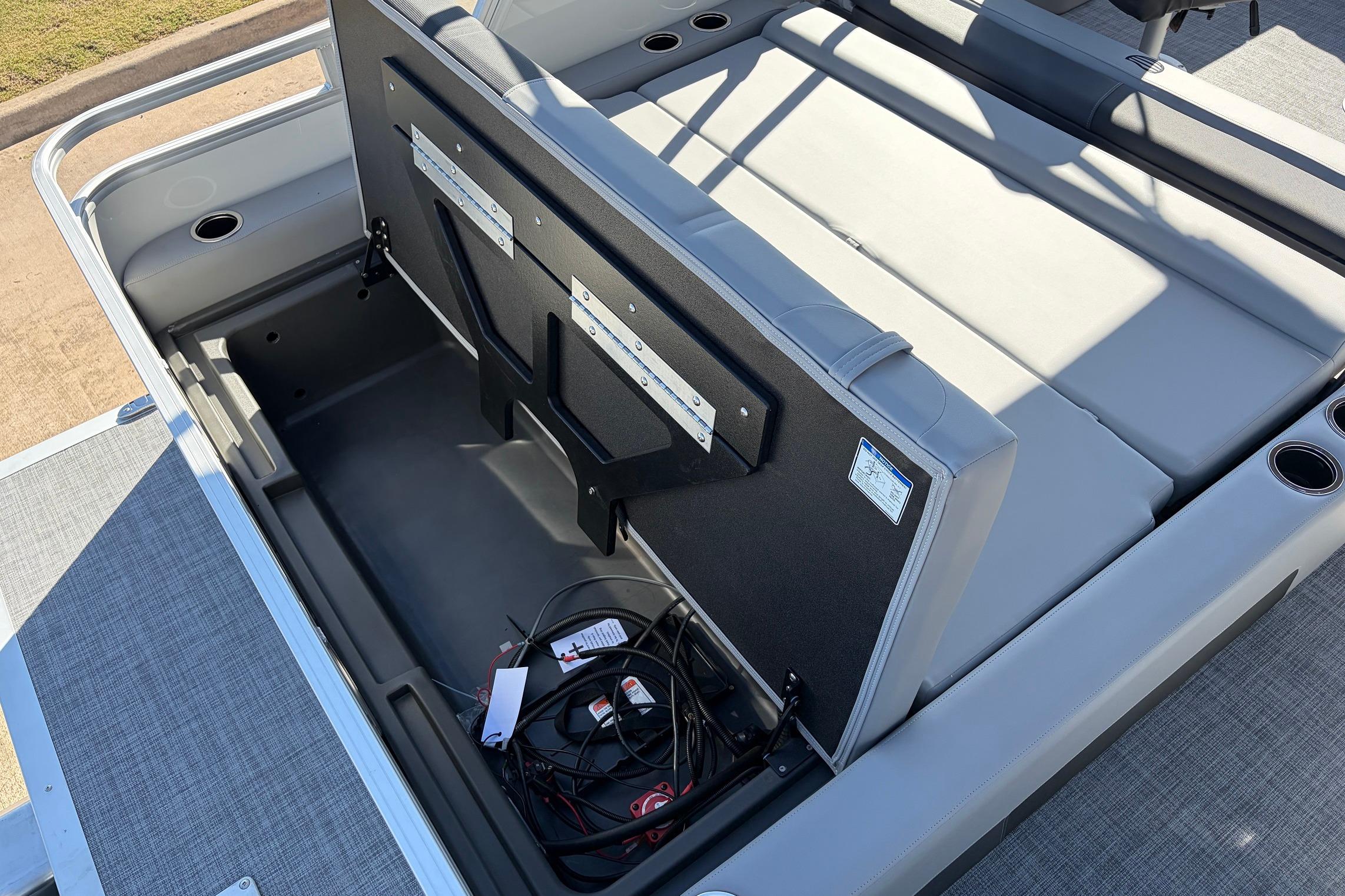 2026 Sun Tracker Party Barge 22 RF XP3 storage compartment with open seat and wiring.