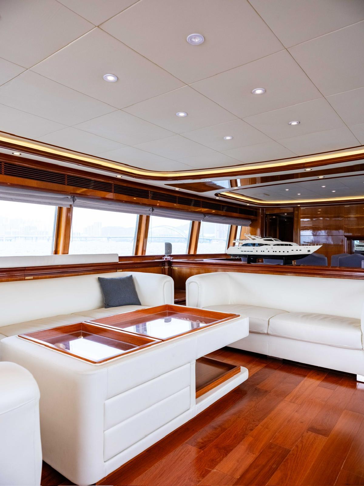 Luxurious interior of 2005 Ferretti Yachts Custom Line 112 with elegant wood and white furnishings.