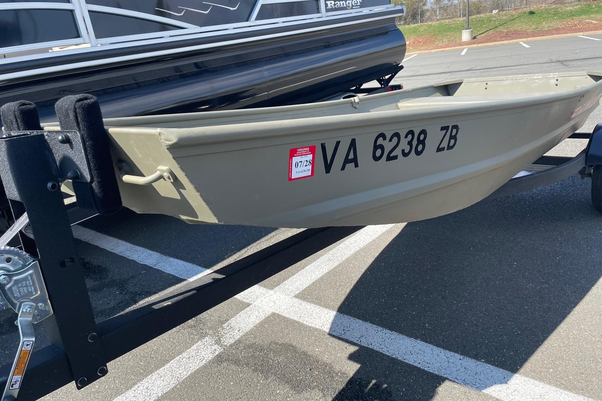2025 Tracker Grizzly 1236 Jon boat on trailer, parked in a lot.