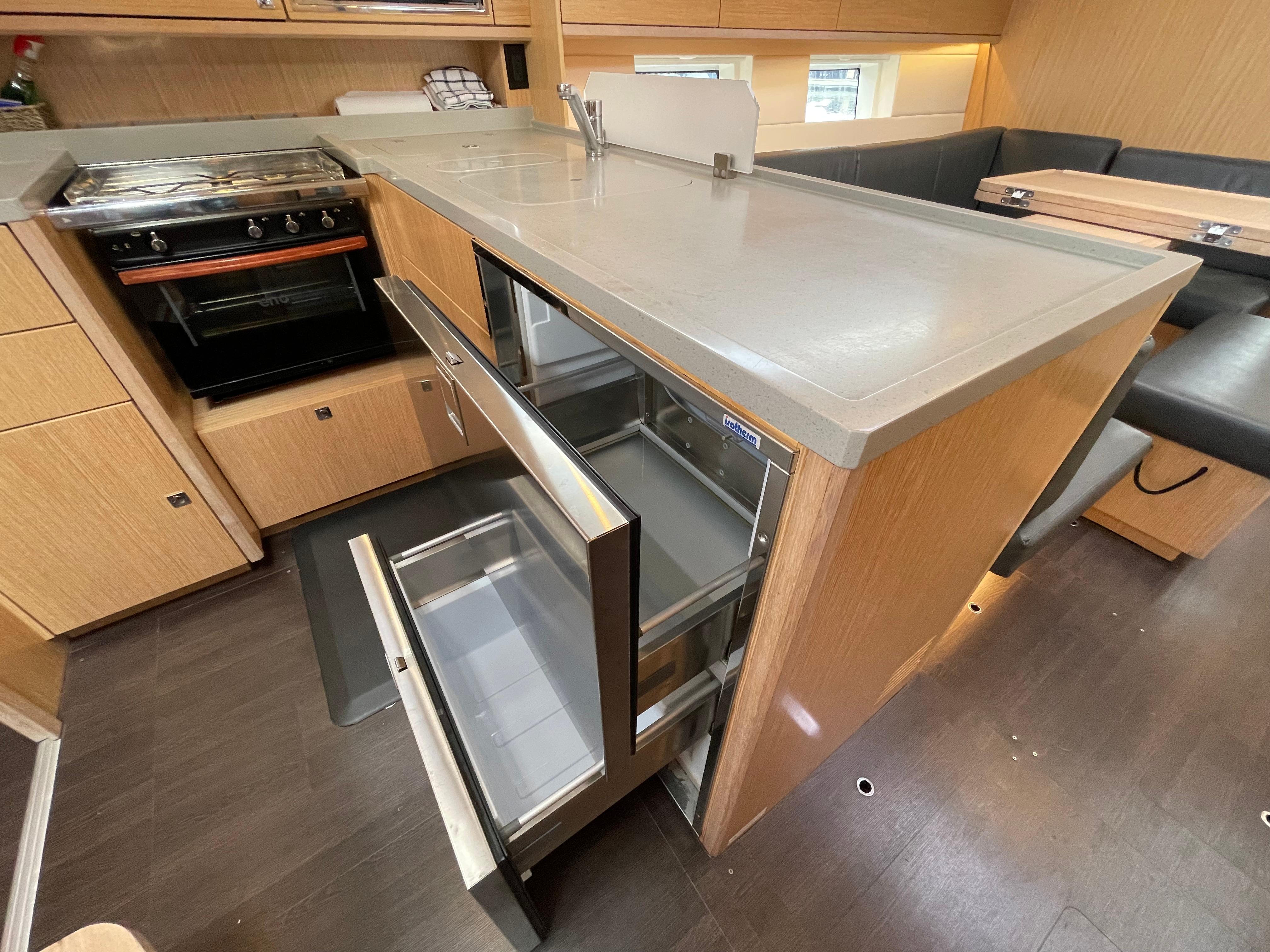 Modern kitchen interior of 2019 Bavaria C45 Style yacht with open fridge and oven.