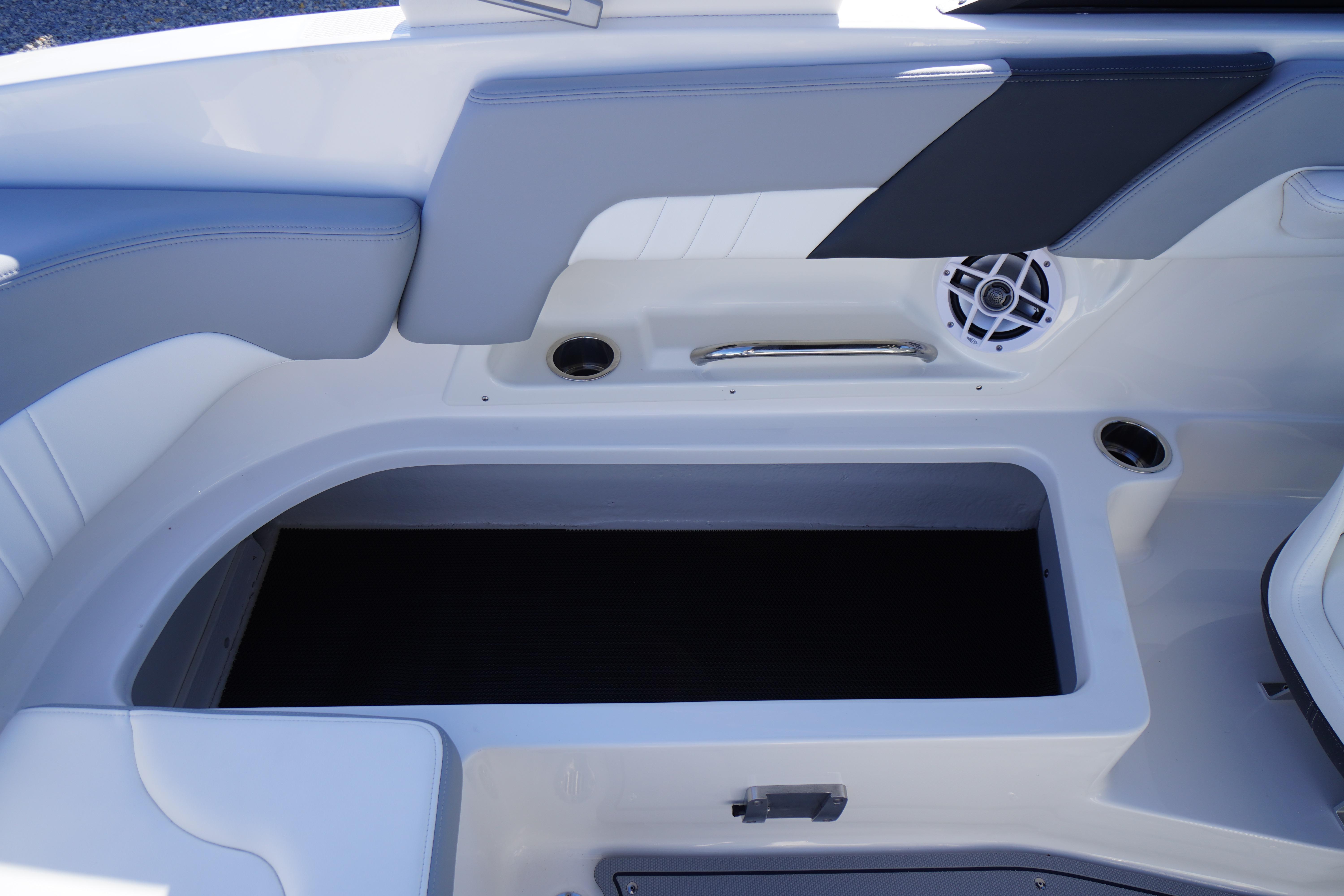 2026 Chaparral 23 SSi OB boat interior with storage compartment and speaker.