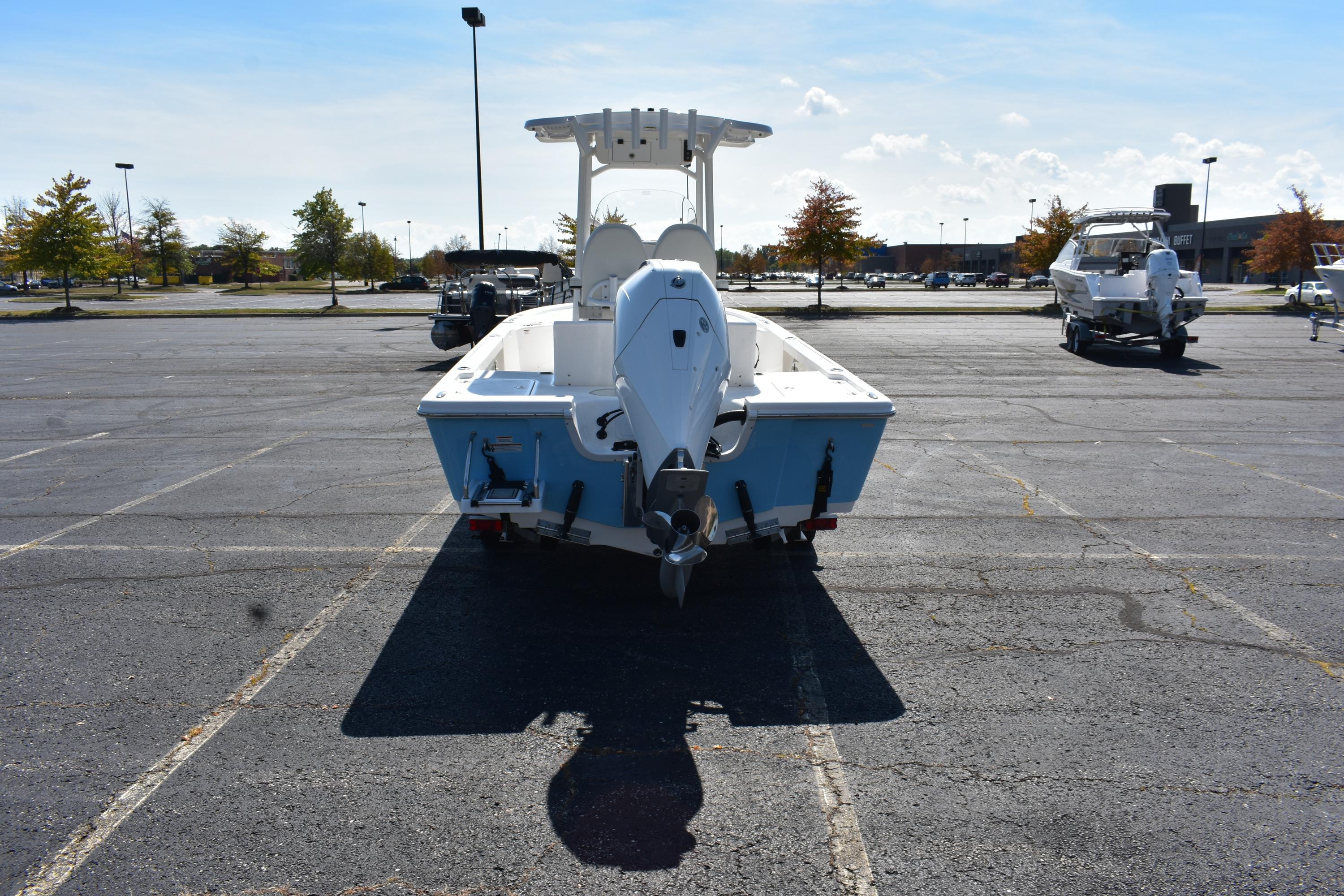 2025 Sea Pro 230 Bay boat parked in an empty lot, rear view.