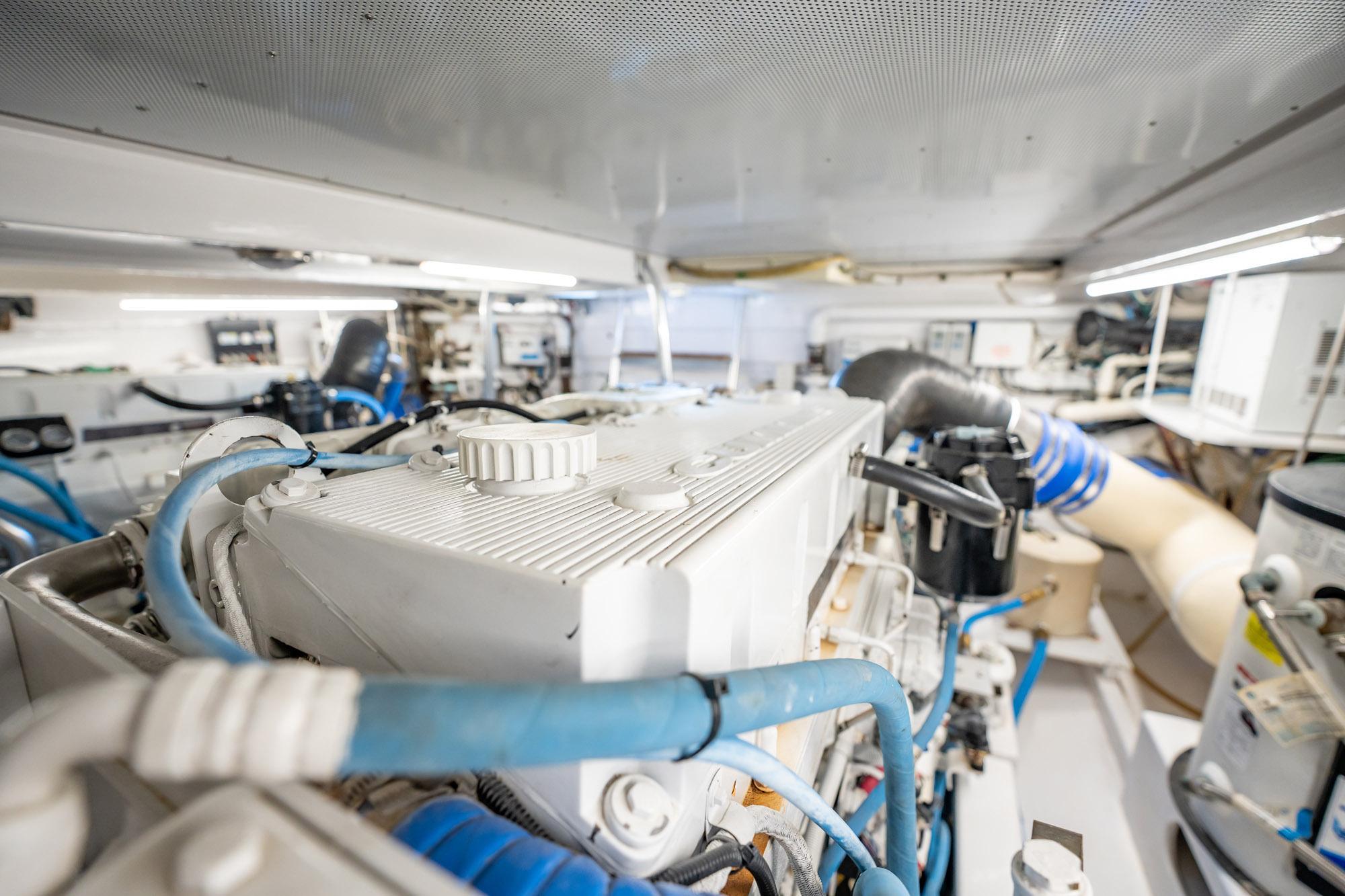 Engine room of 1983 Rybovich 55 Convertible yacht with visible machinery and pipes.