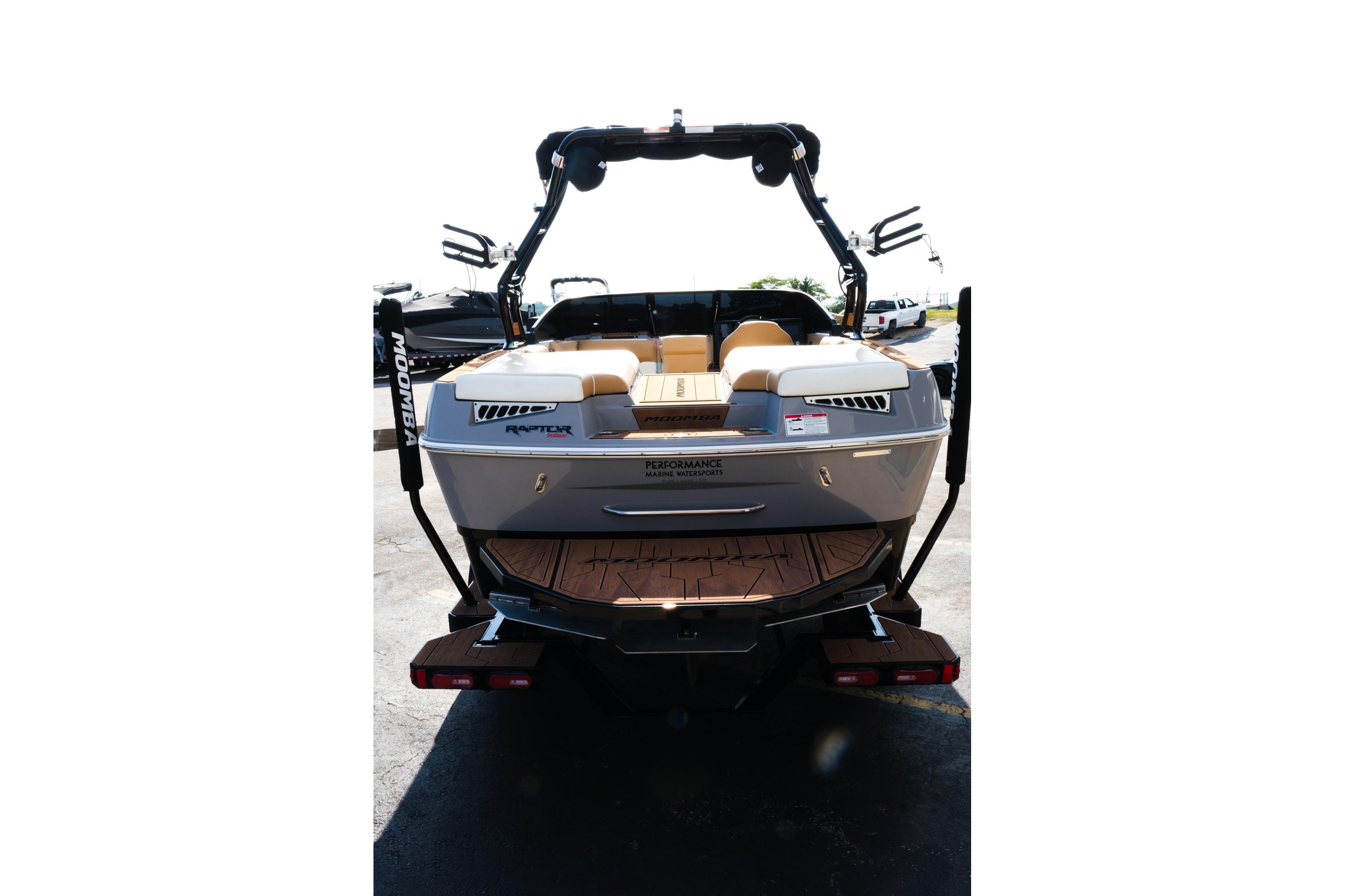 2023 Moomba Mondo boat rear view with wakeboard tower and seating.