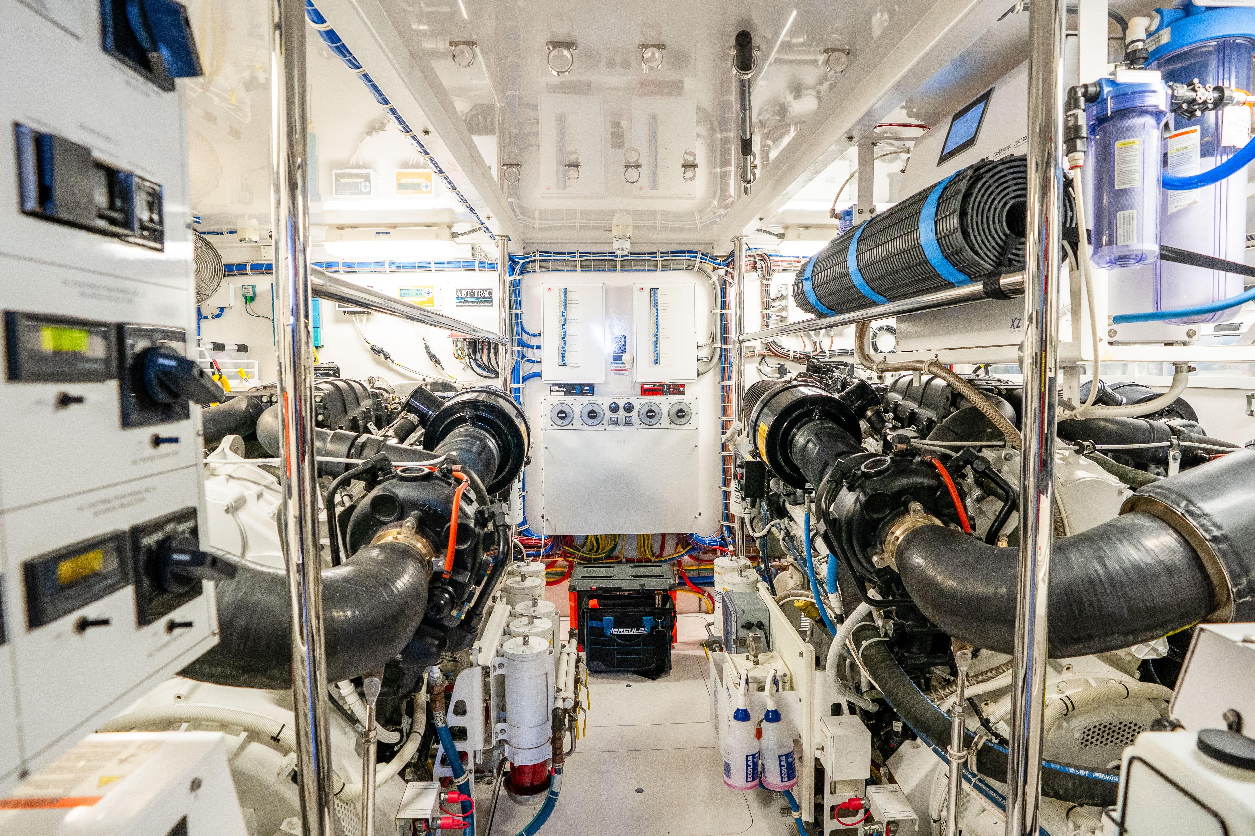 Engine room of 2021 Hatteras M75 Panacera yacht, showcasing advanced machinery and controls.