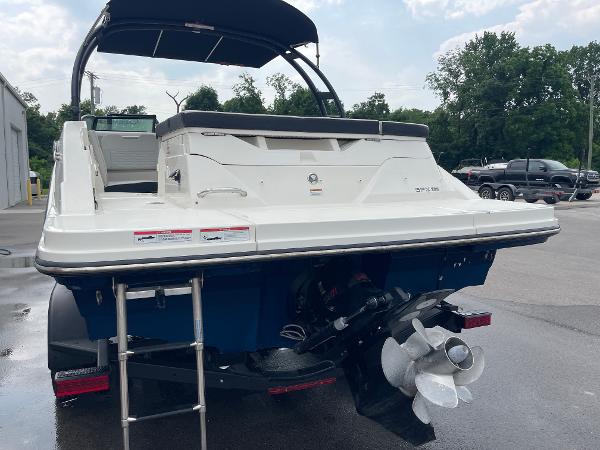2023 Sea Ray SPX 230 boat rear view with ladder and propeller, parked outdoors.