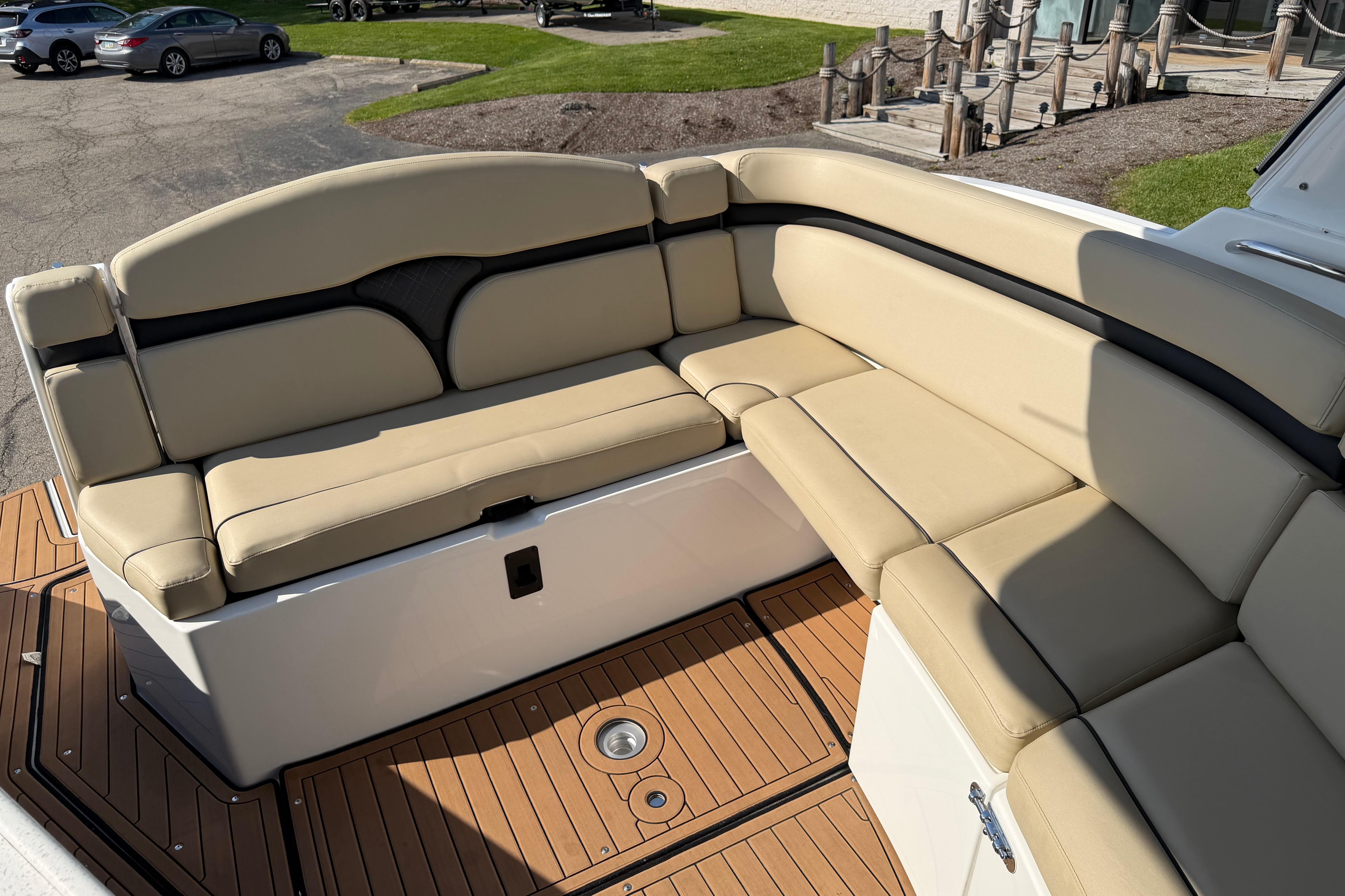 2019 Rinker EX 320 boat interior with beige seating and teak flooring.