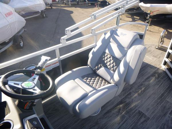 2024 Ranger Reata 223C boat interior with luxurious captain's chair and steering wheel.