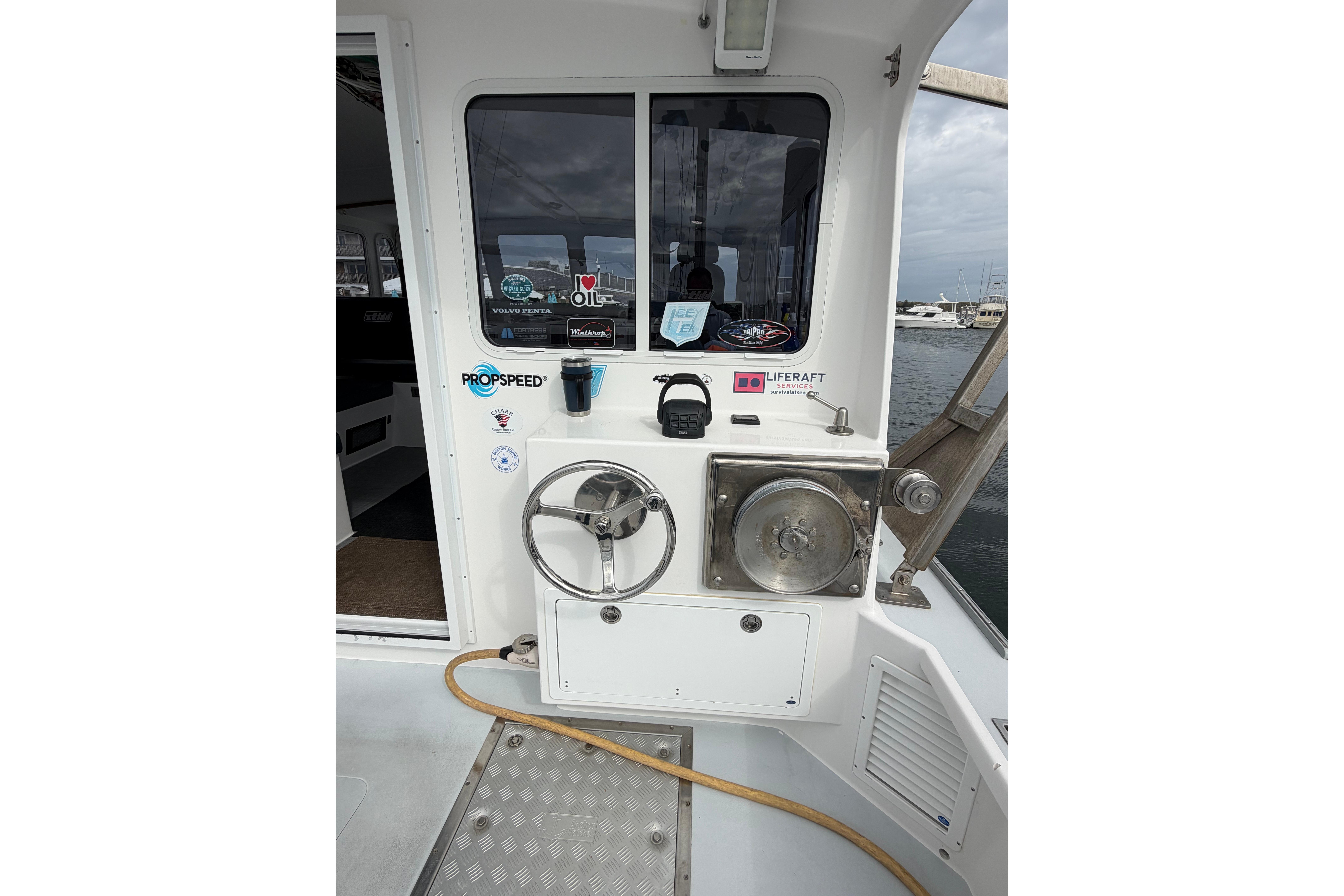 2018 H&H Marine Osmond Beal boat helm with steering wheel and control panel.