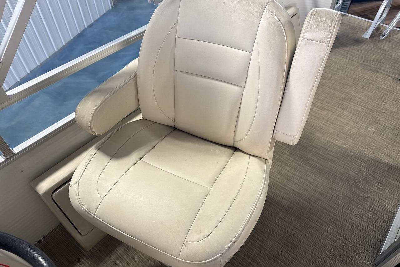 Beige captain's chair on 2018 Landau Alure 212 Fish boat, with armrests and cushioned seat.