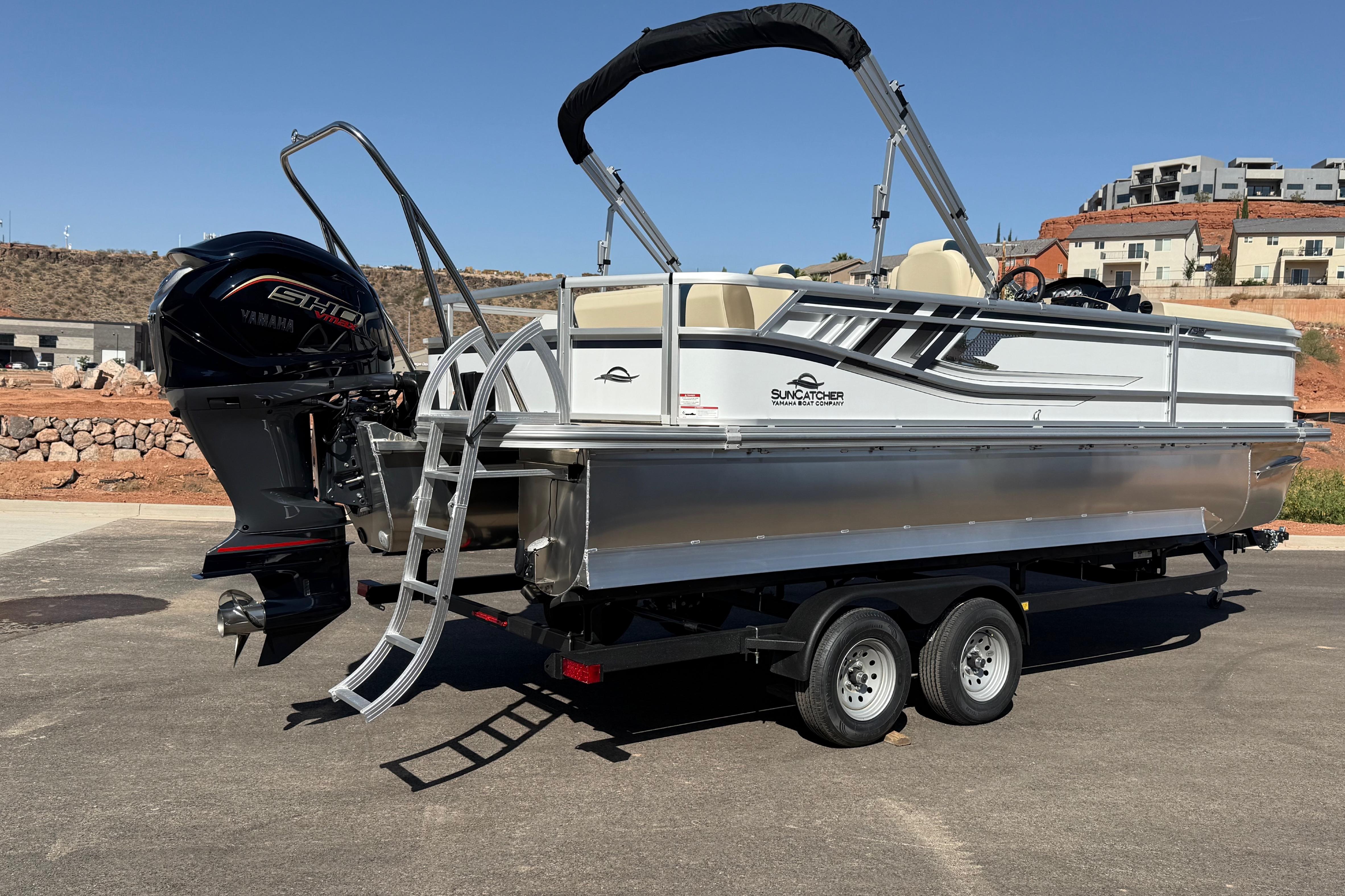 2026 SunCatcher Select 322SL pontoon boat on trailer, featuring Yamaha engine.