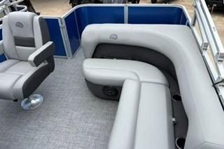 2026 Sun Tracker Party Barge 18 DLX interior with gray seating and blue accents.