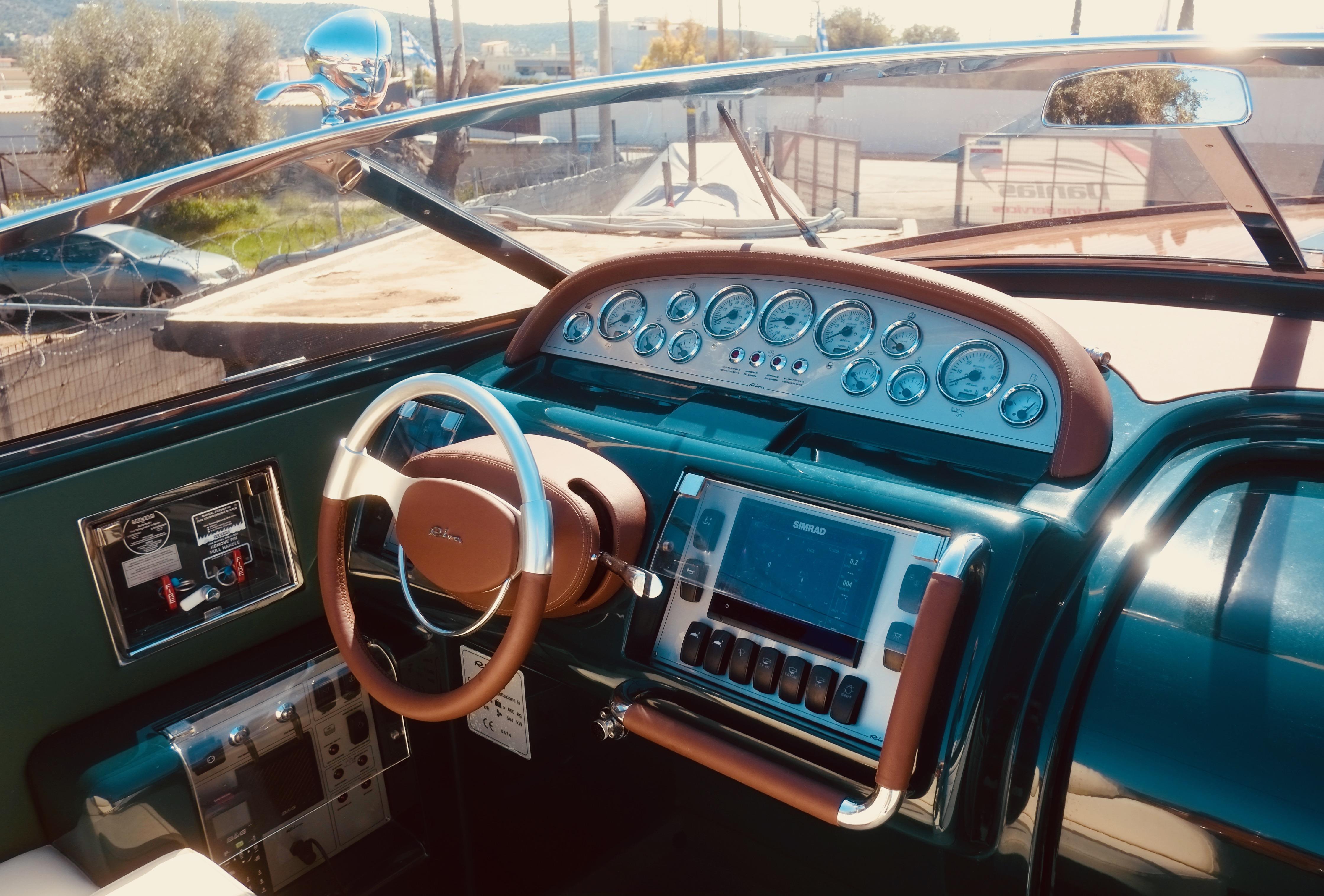 2003 Riva Aquariva 33 dashboard with classic steering wheel and modern navigation instruments.