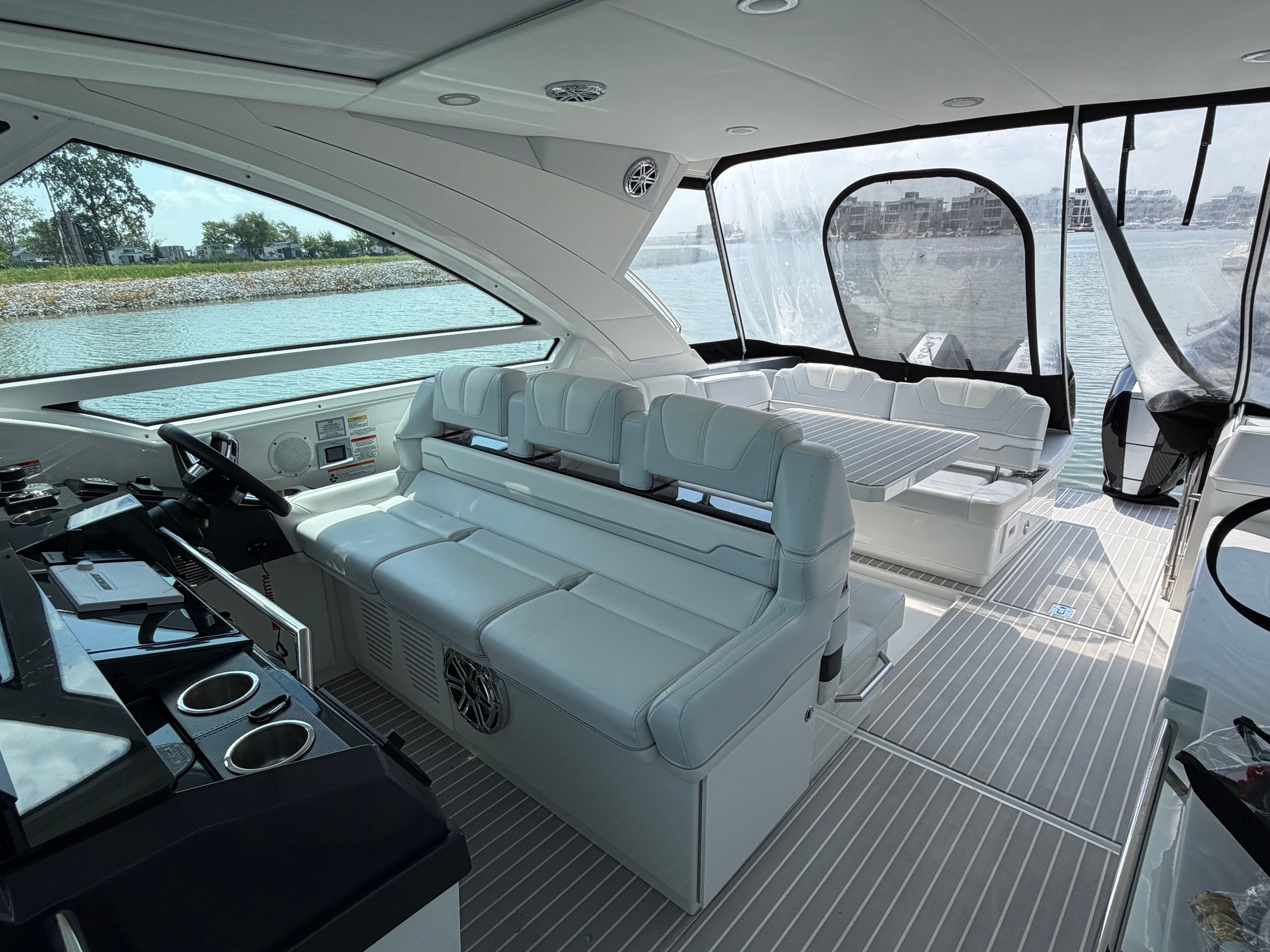 The image shows the interior of a 2023 Formula 400 Super Sport Crossover. There are white leather seats and a modern dashboard.