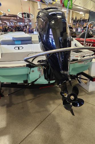 2025 Tahoe T16 boat with outboard motor displayed indoors.