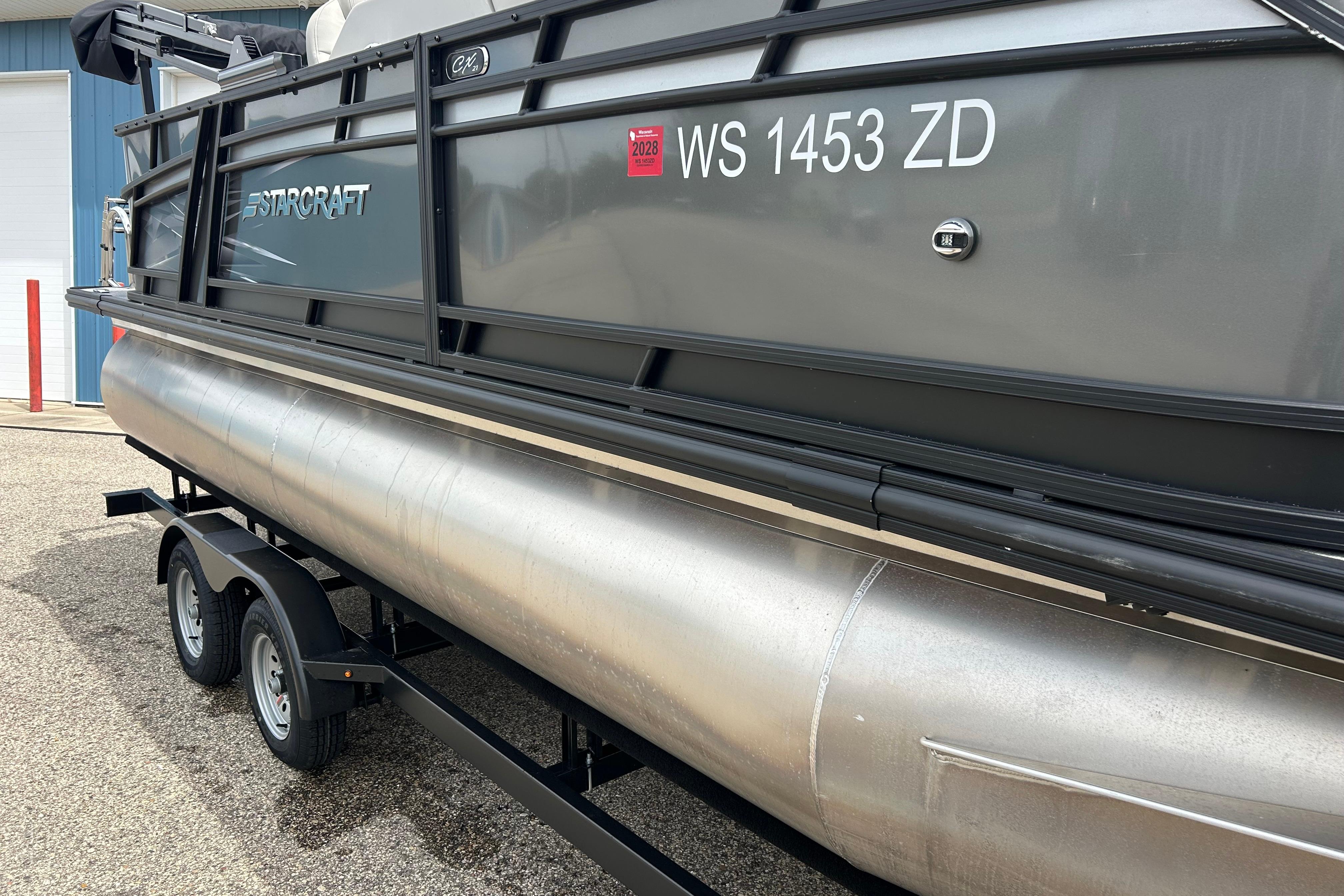 2022 Starcraft CX 21 C pontoon boat on trailer, side view with registration number.