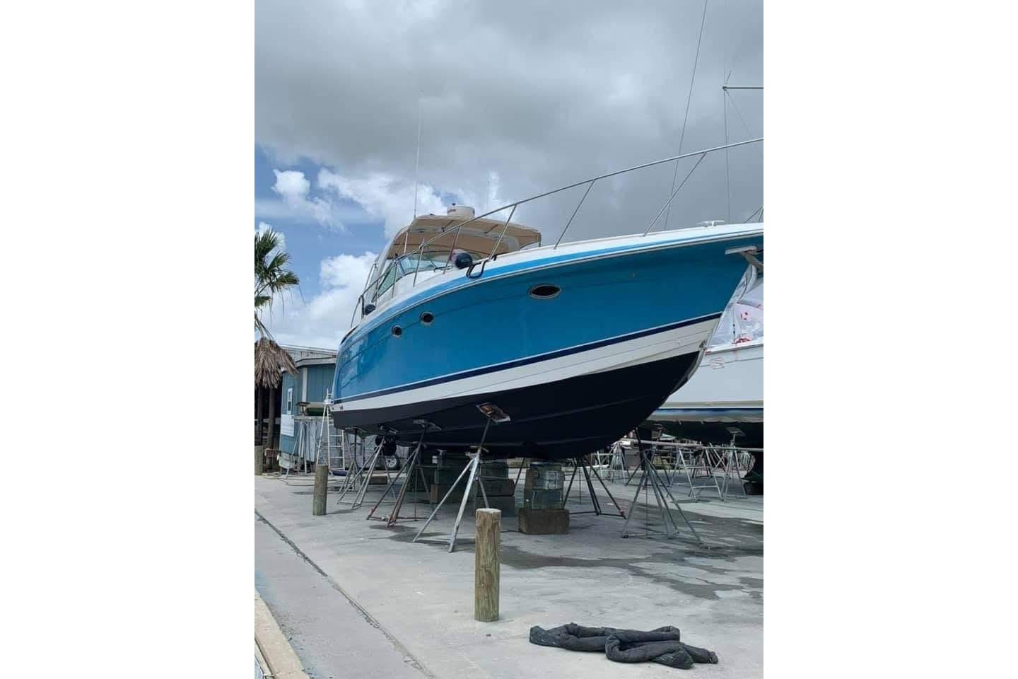 2003 Formula 40 Performance Cruiser in dry dock, blue hull, overcast sky.