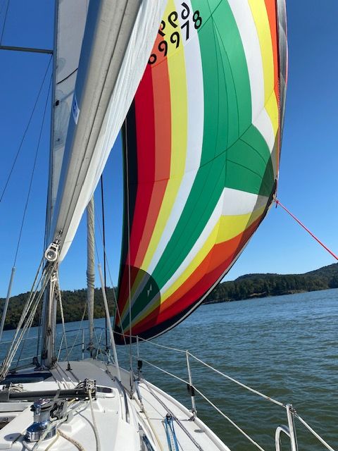 Colorful sails on Catalina 320 yacht, 2001, on calm waters.