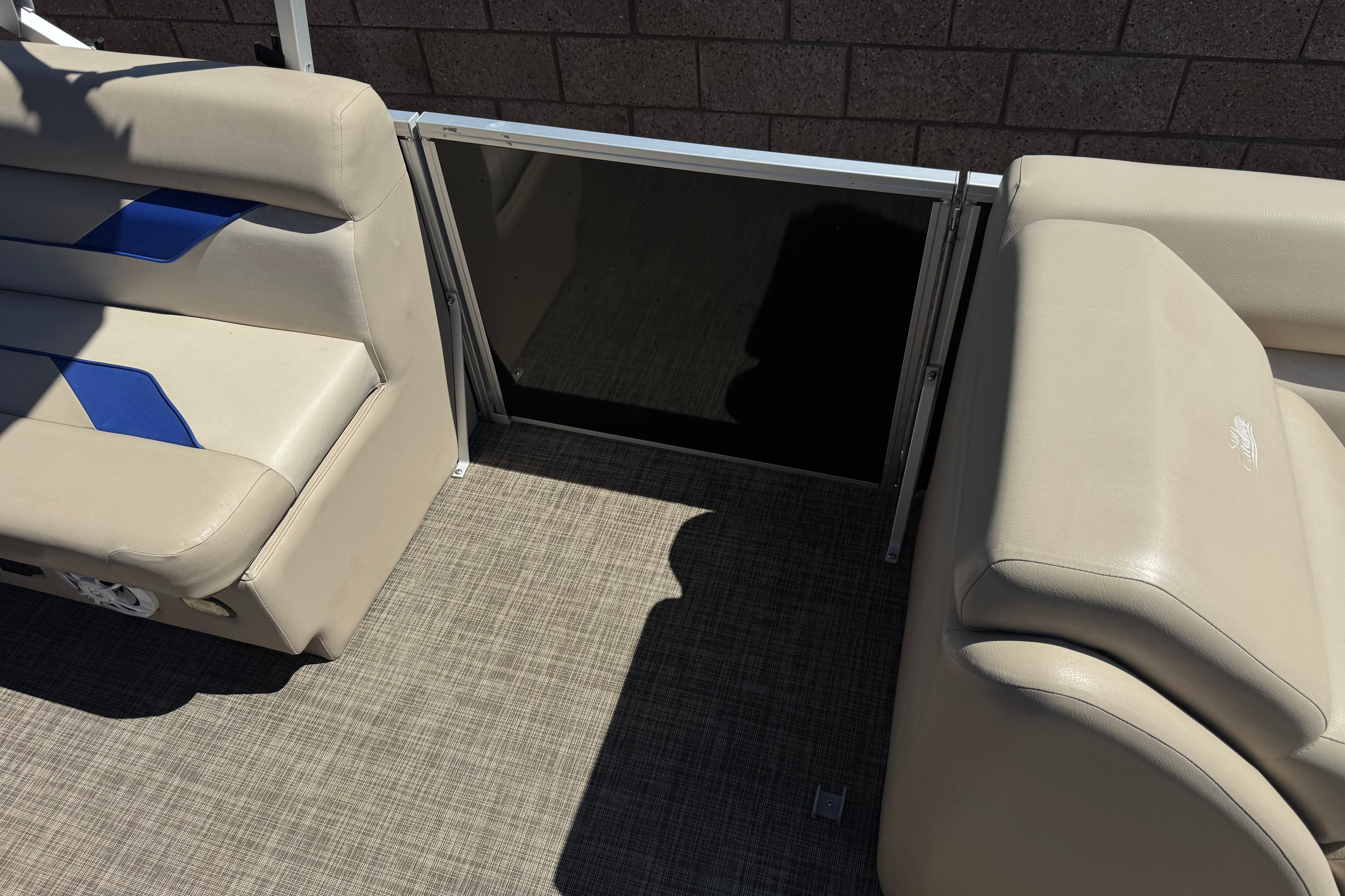 2021 SunCatcher Select 20RCX boat interior with beige seating and blue accents.