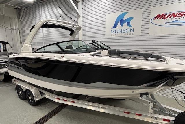 2026 Chaparral SSX 8 boat on trailer in showroom, Munson Surf & Wake signage visible.