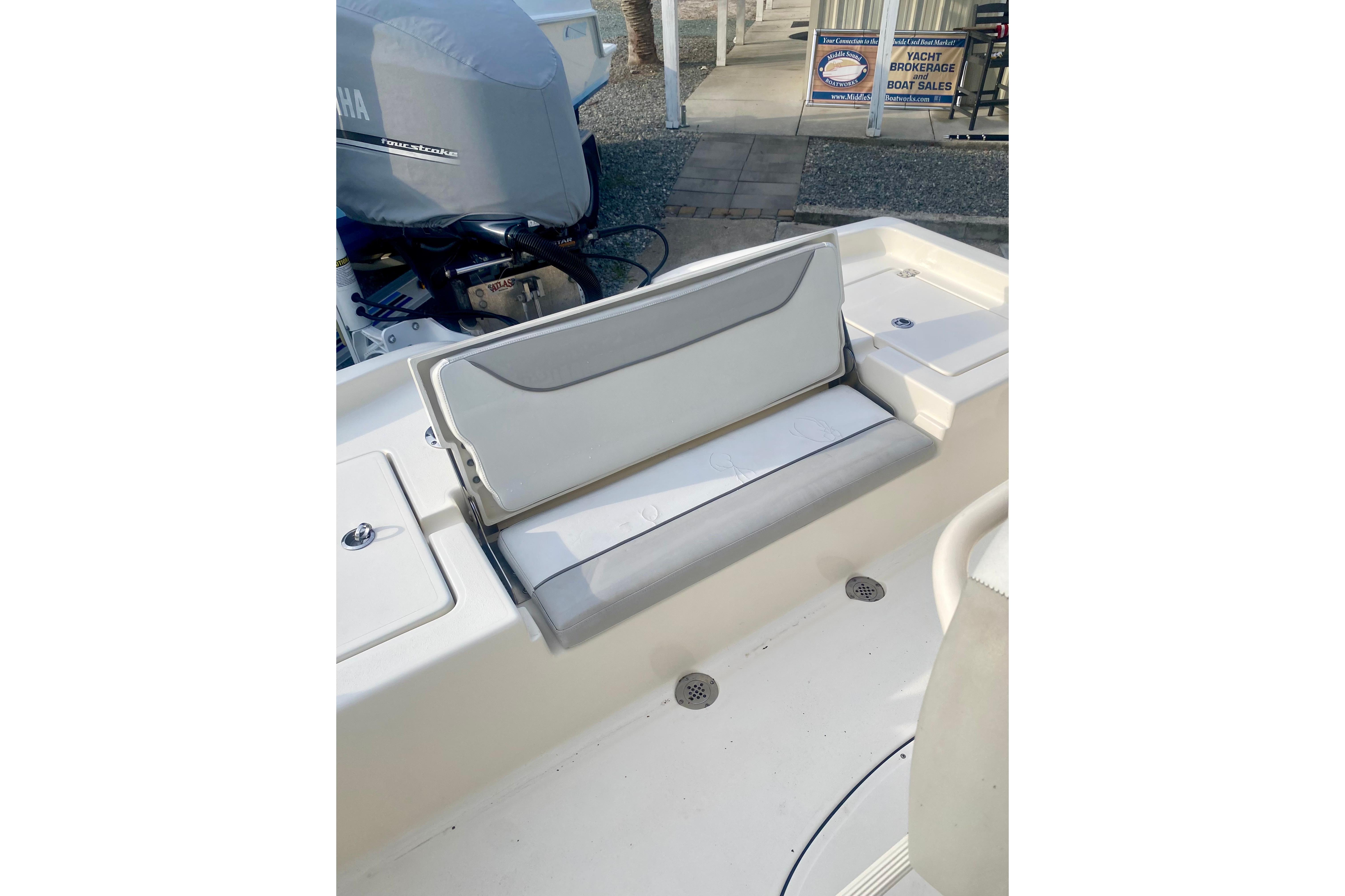 2018 Avenger AV24 boat interior with foldable seat and Yamaha outboard motor.