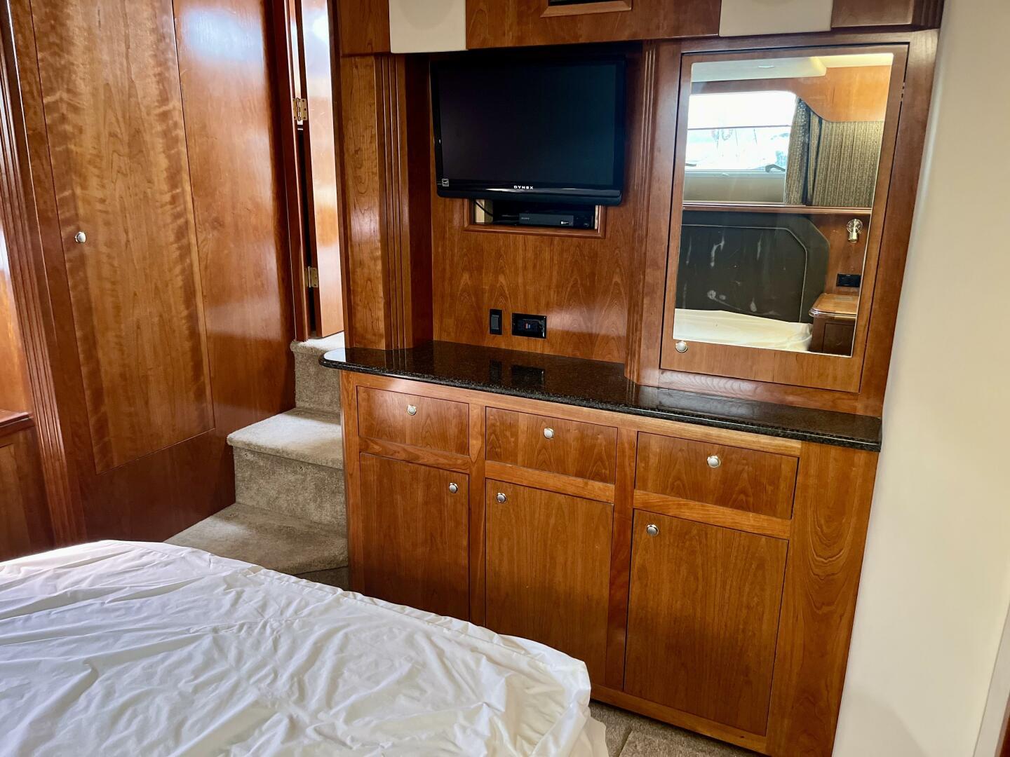 Interior of 2005 Cruisers Yachts 405 Express Motor Yacht with wood cabinetry and TV.