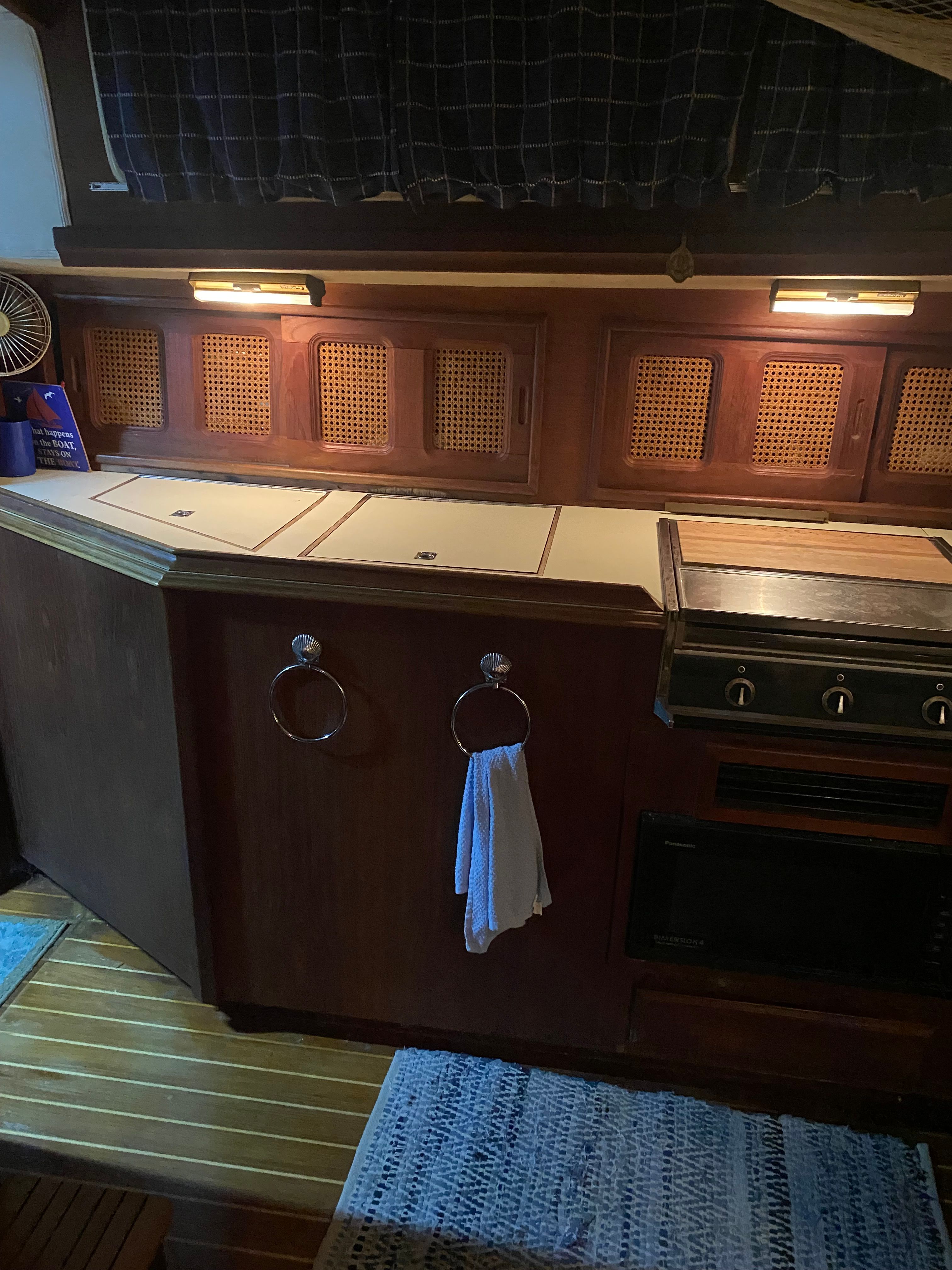Interior of a 1983 Islander Freeport with wooden cabinetry and kitchen area.