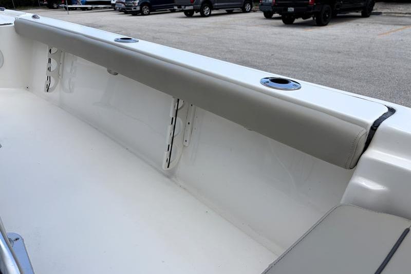 2025 Key West 210 Bay Reef boat interior with rod holders and cushioned seating.