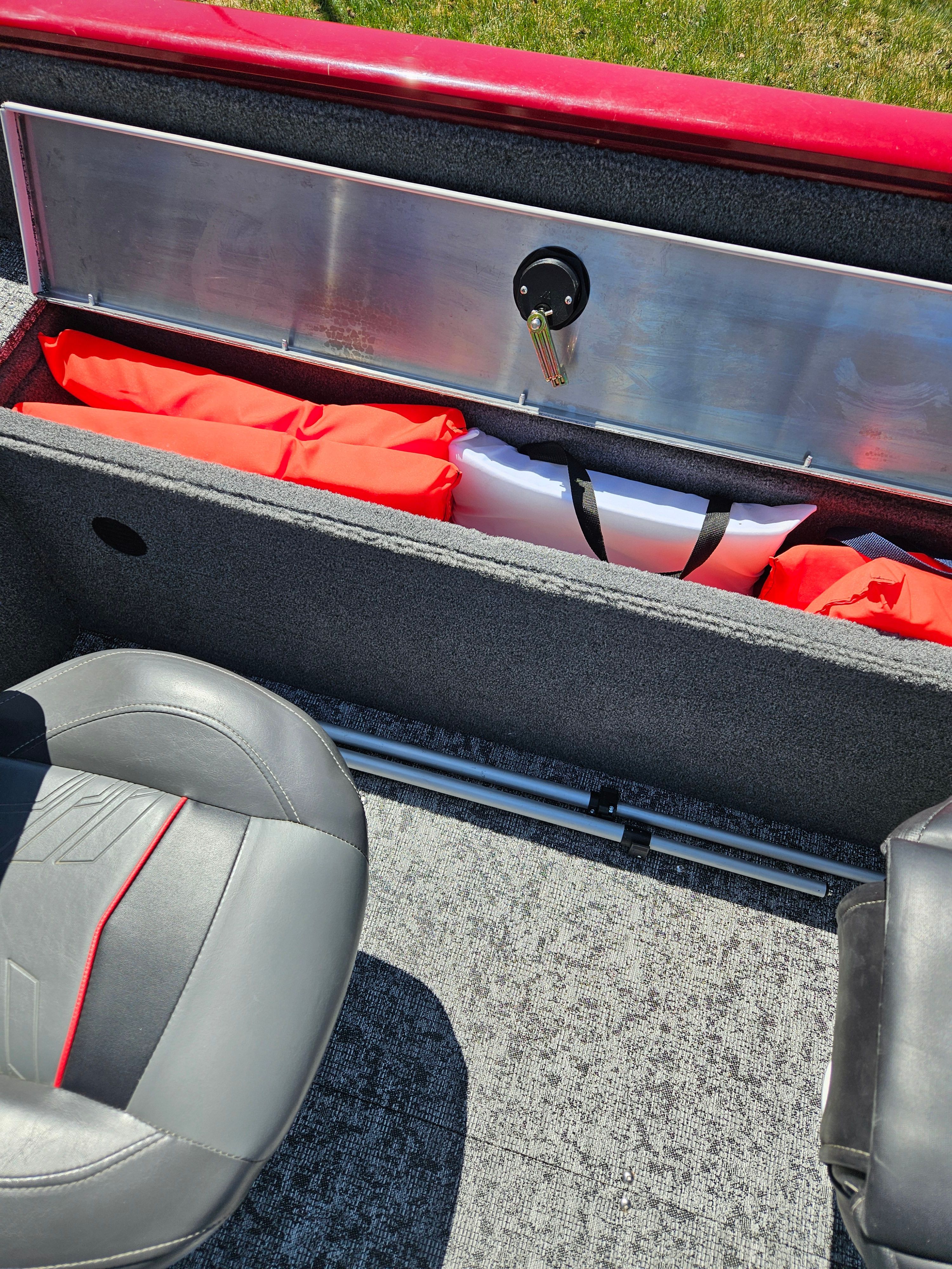 Interior of Tracker Pro Guide V-175 WT boat, seat and storage compartment visible.