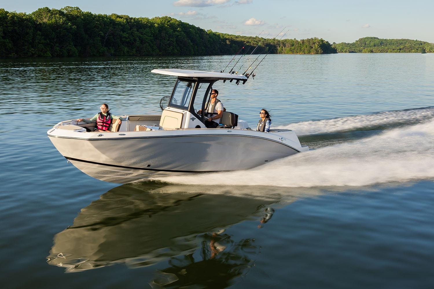 Manufacturer Provided Image: 2026 Yamaha Boats 255 FSH Sport H cruising on a serene lake with passengers.