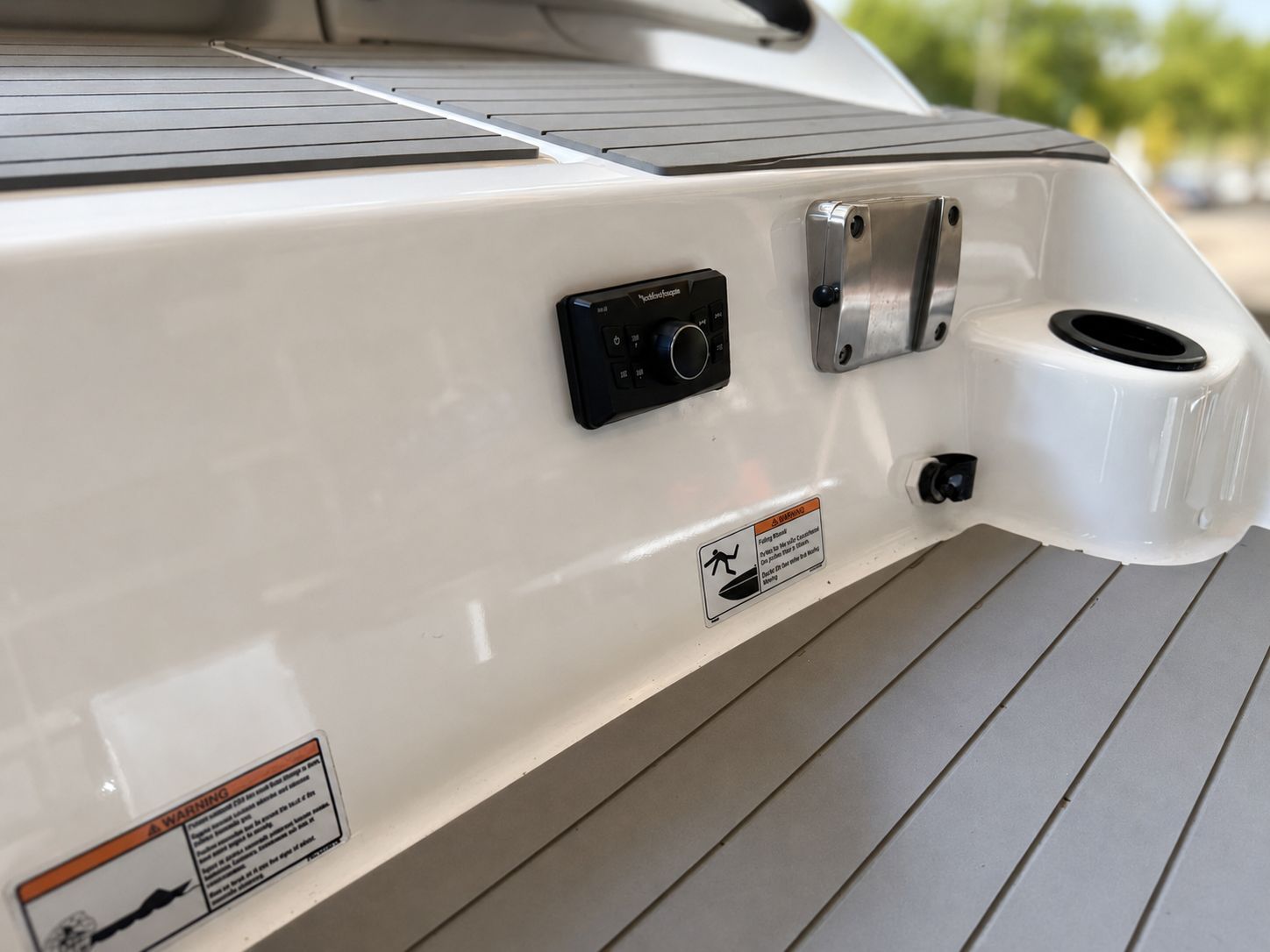 The image shows the stern of a Yamaha SX210 boat with controls and a cup holder.
