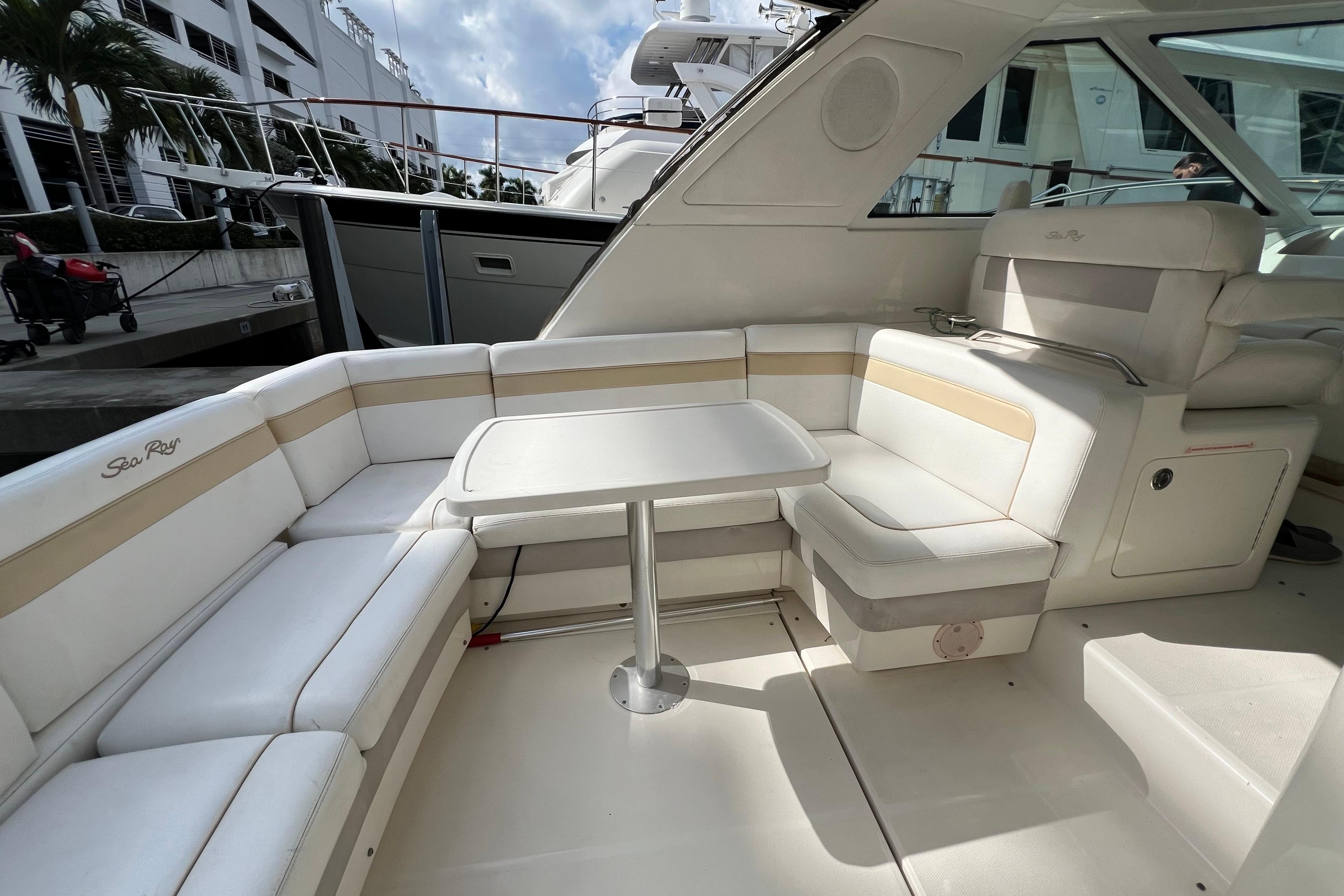 Luxurious 2010 Sea Ray 450 Sundancer yacht interior with elegant seating and table.