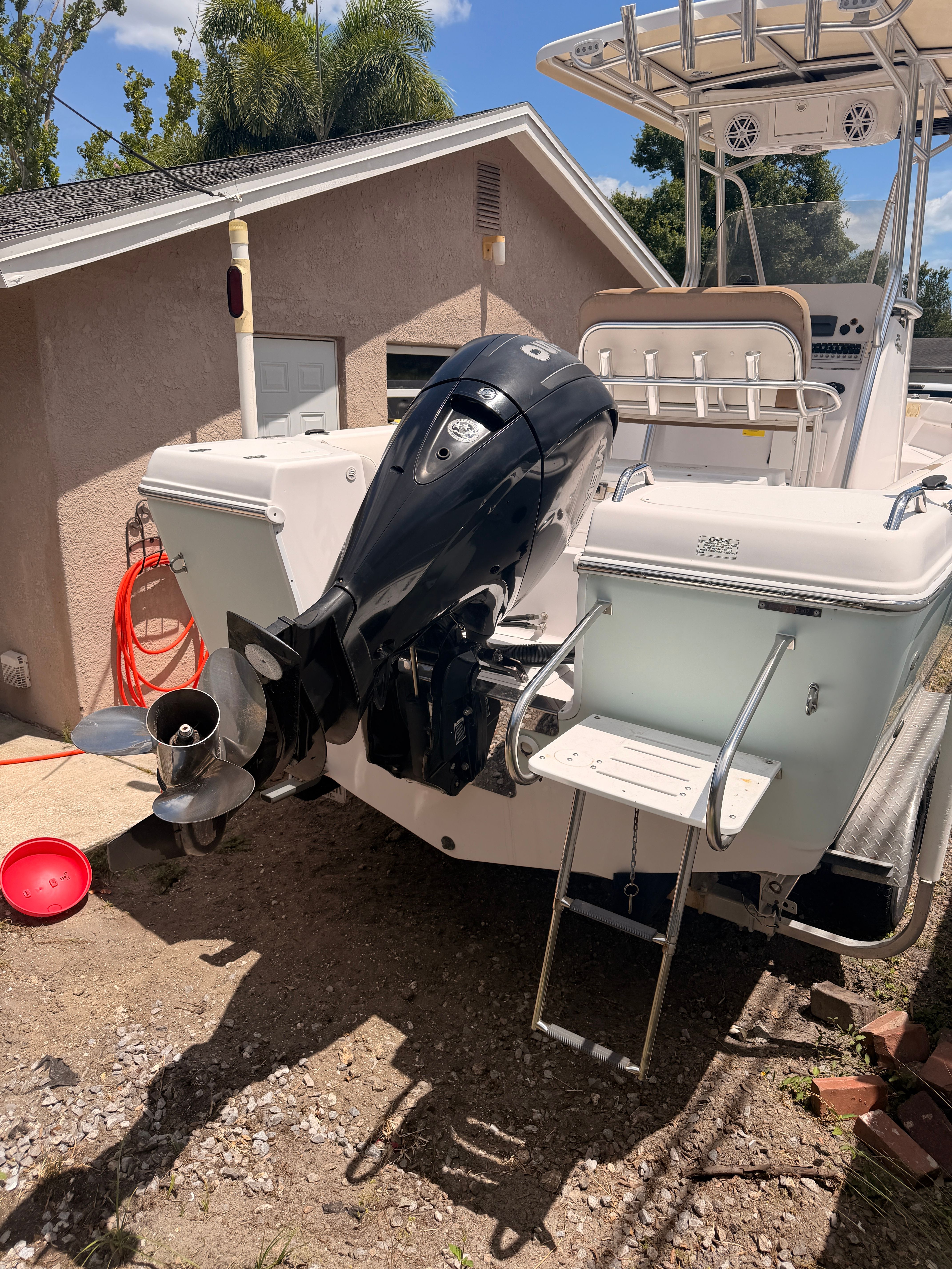 2017 Pro-Line 20 Sport boat with outboard motor in yard.