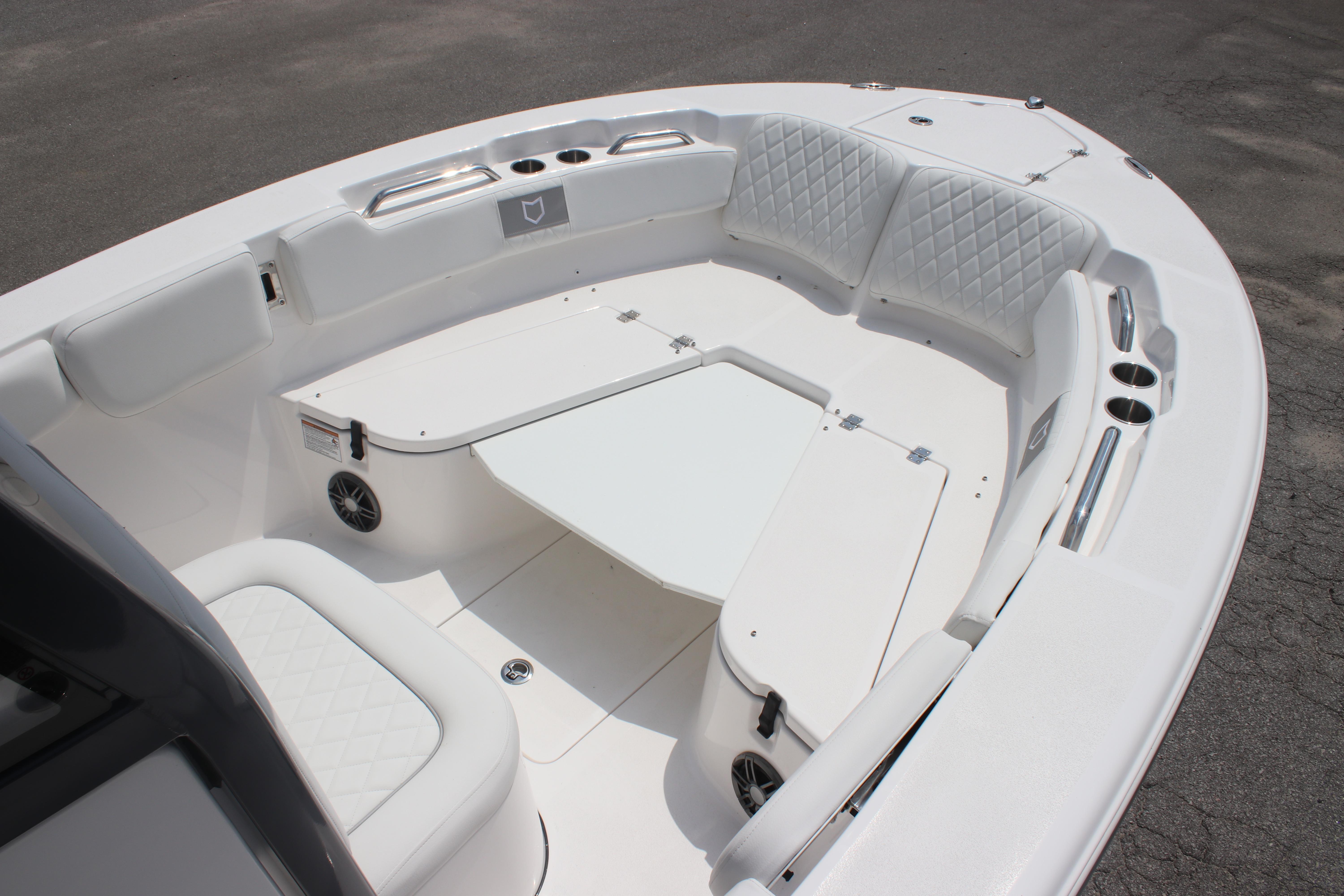 2026 Sea Fox 248 Commander boat interior with white seating and table.