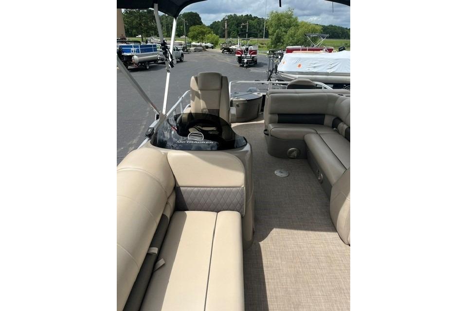 2023 SUNTRACKER Fishing Barge 20 interior with beige seating and steering console.