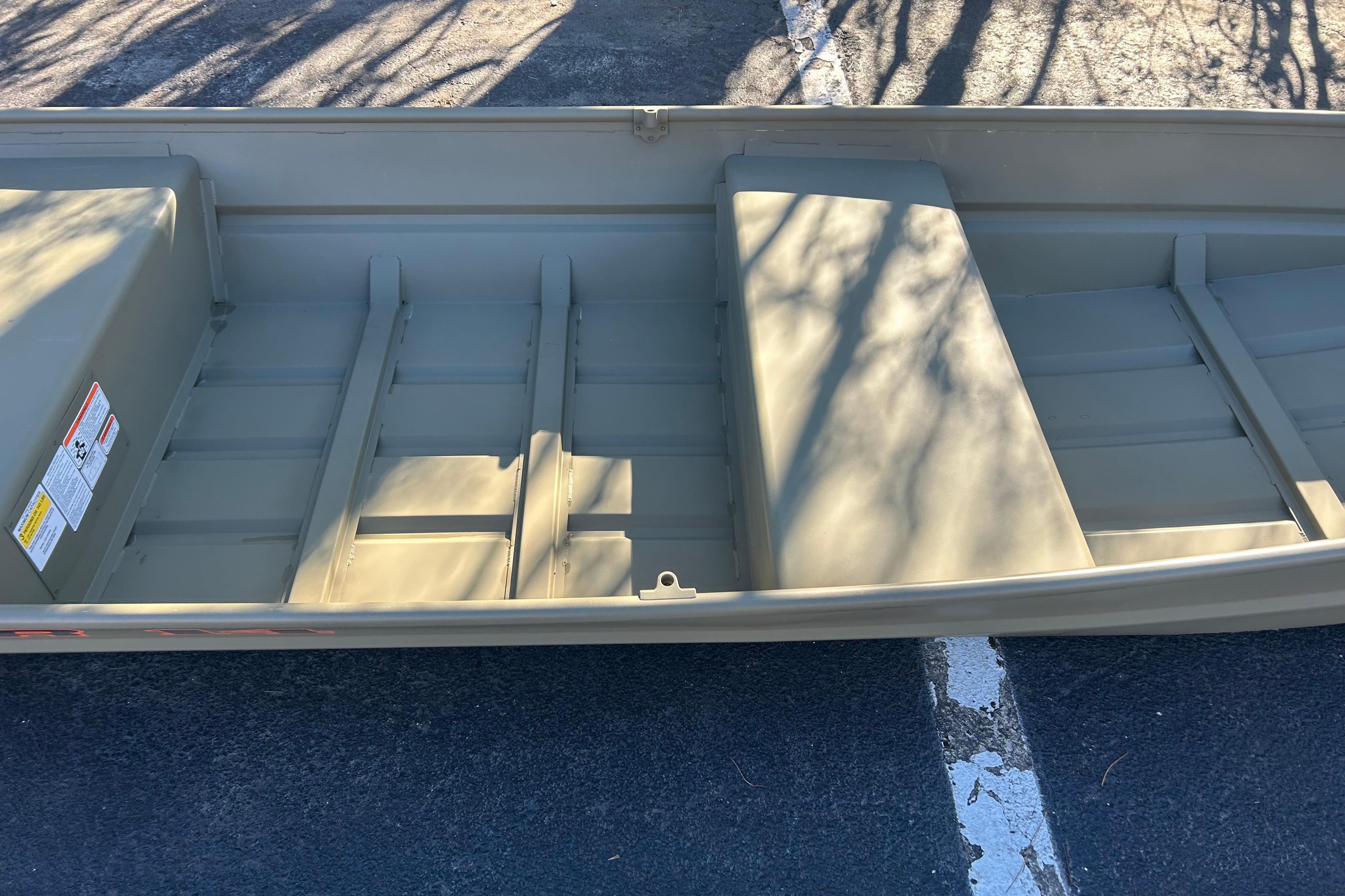 2026 Tracker Grizzly 14 Jon boat interior with bench seats and storage compartments.