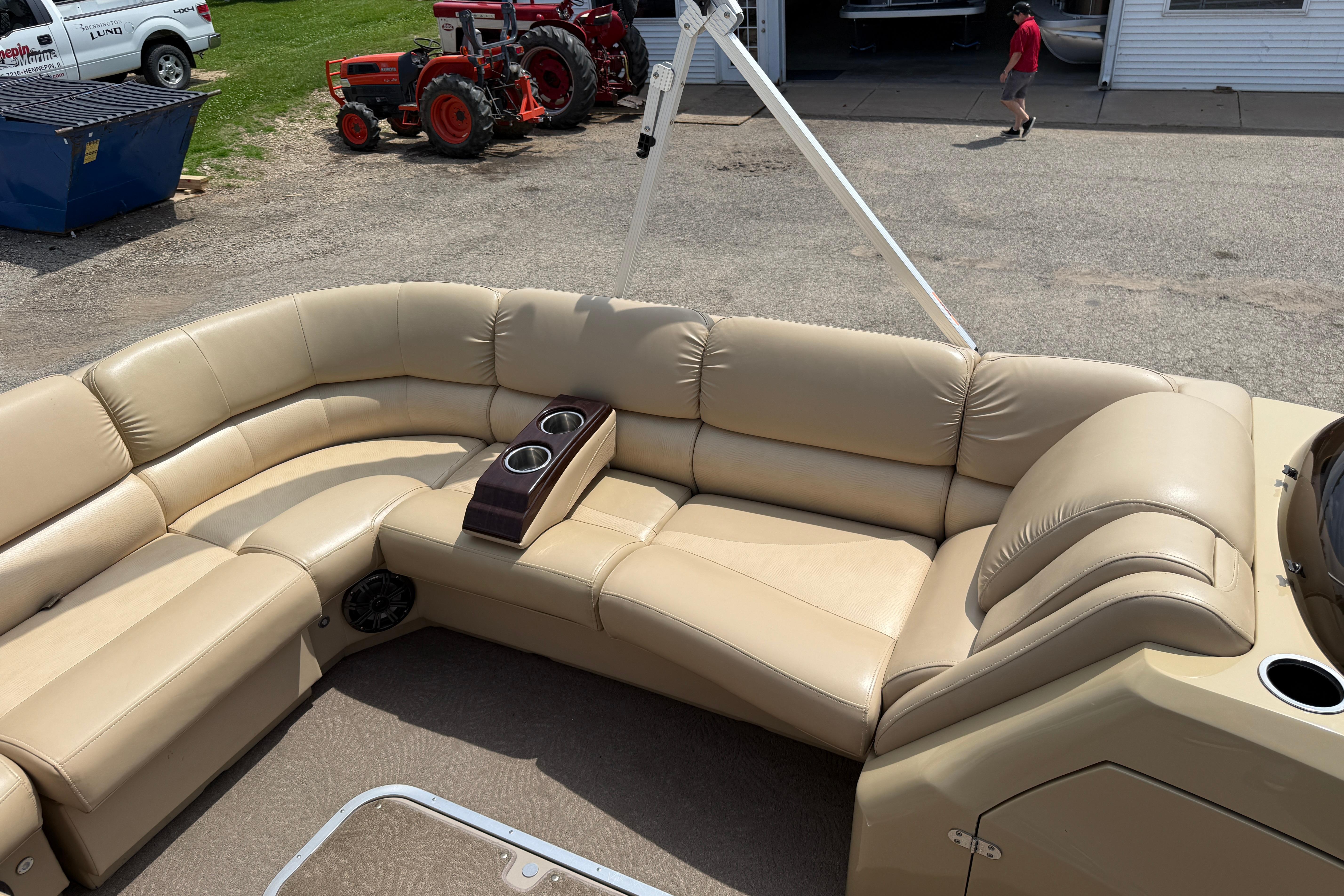 Luxurious seating on a 2011 Bennington 2575QCW I/O boat with beige upholstery.