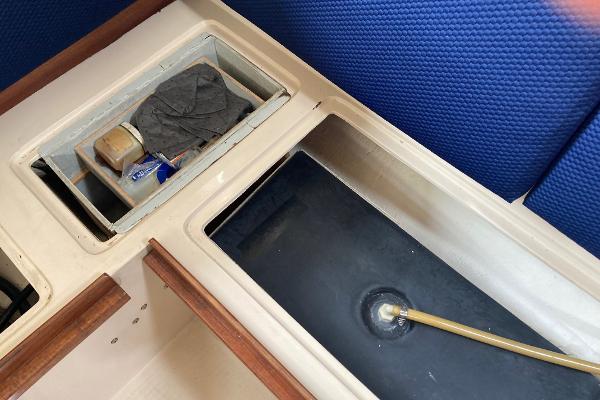 Interior view of a 1989 Catalina 30 sailboat showing storage compartments.