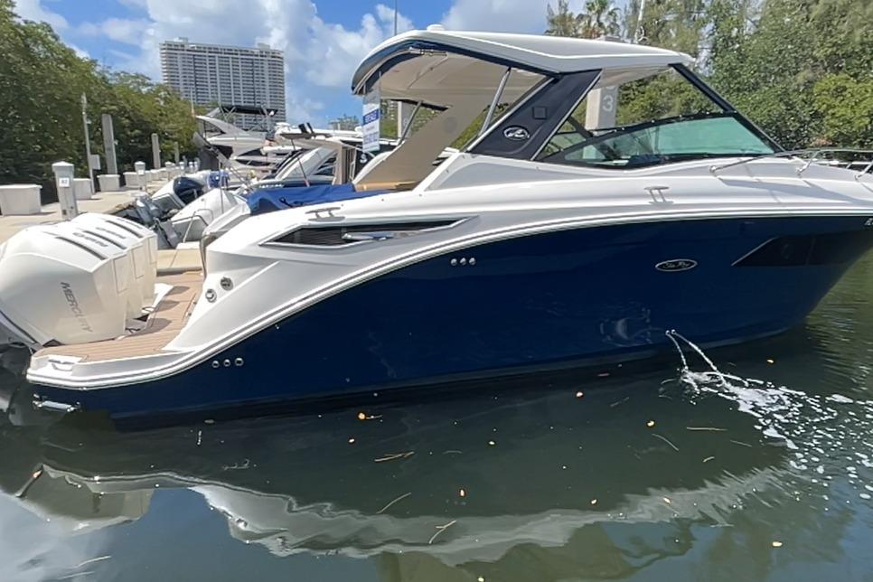 2020 Sea Ray Sundancer 320 Outboard docked, featuring sleek blue and white design.