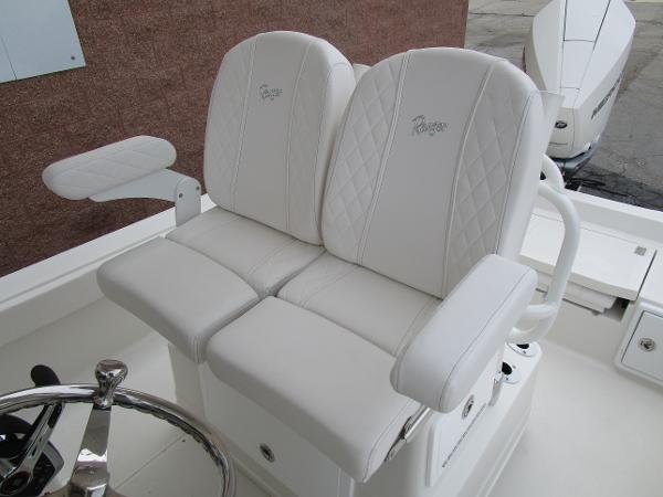 2024 Ranger 2360 Bay boat with white cushioned seats and steering wheel.