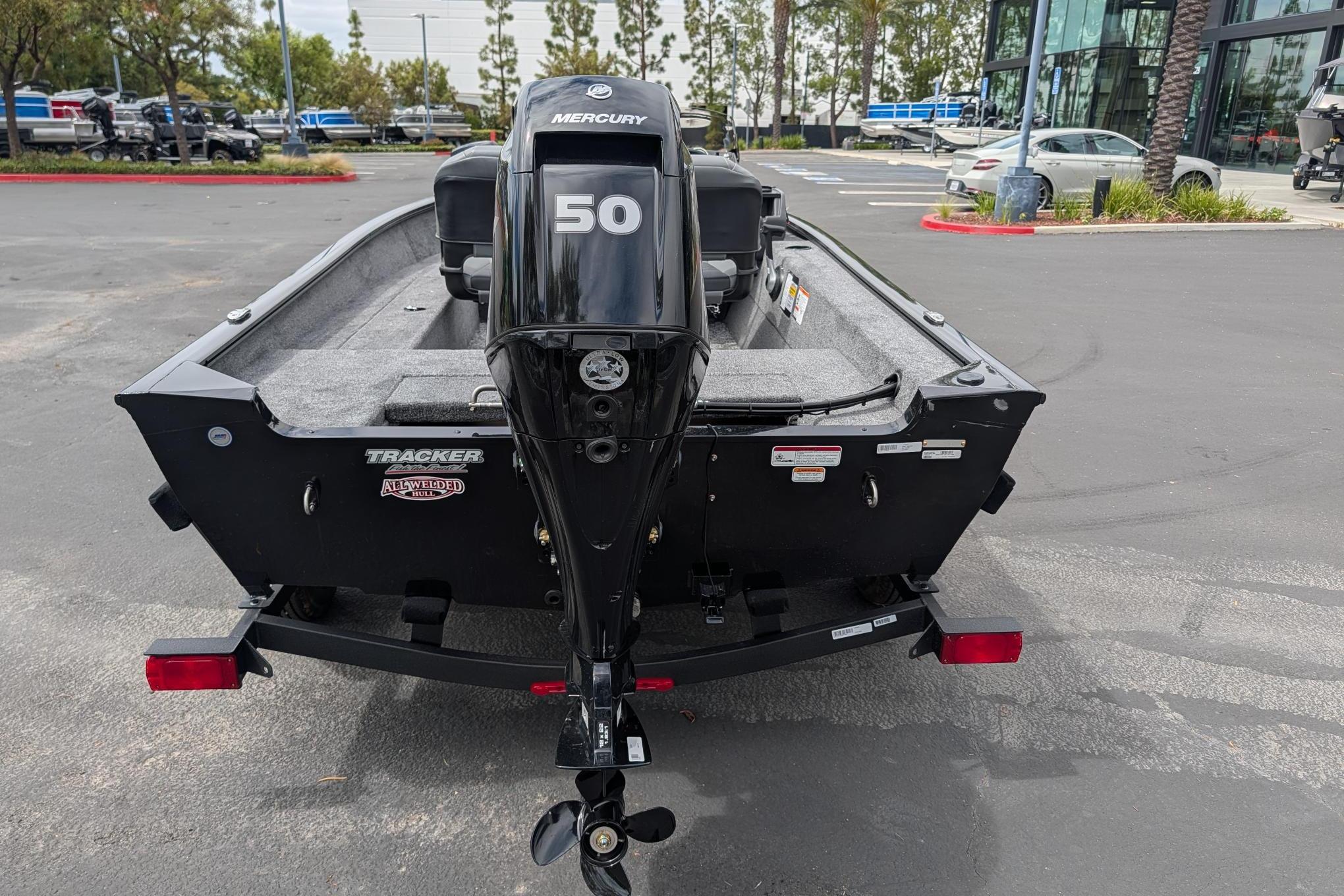 2026 Tracker Super Guide V-16 SC boat with Mercury 50 engine in parking lot.