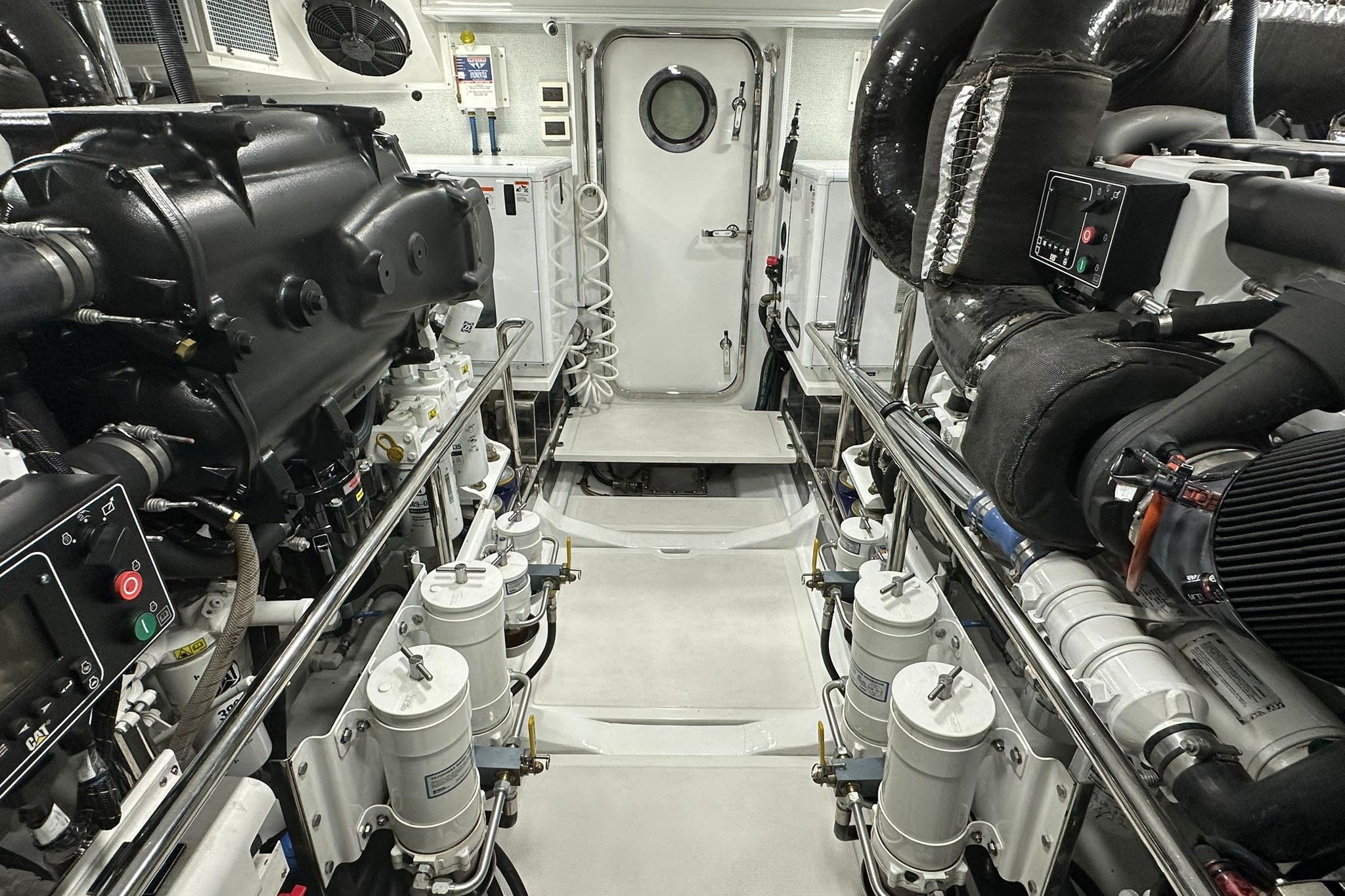 Engine room of 2023 Marlow Explorer 66E-CB yacht, showcasing advanced machinery and equipment.