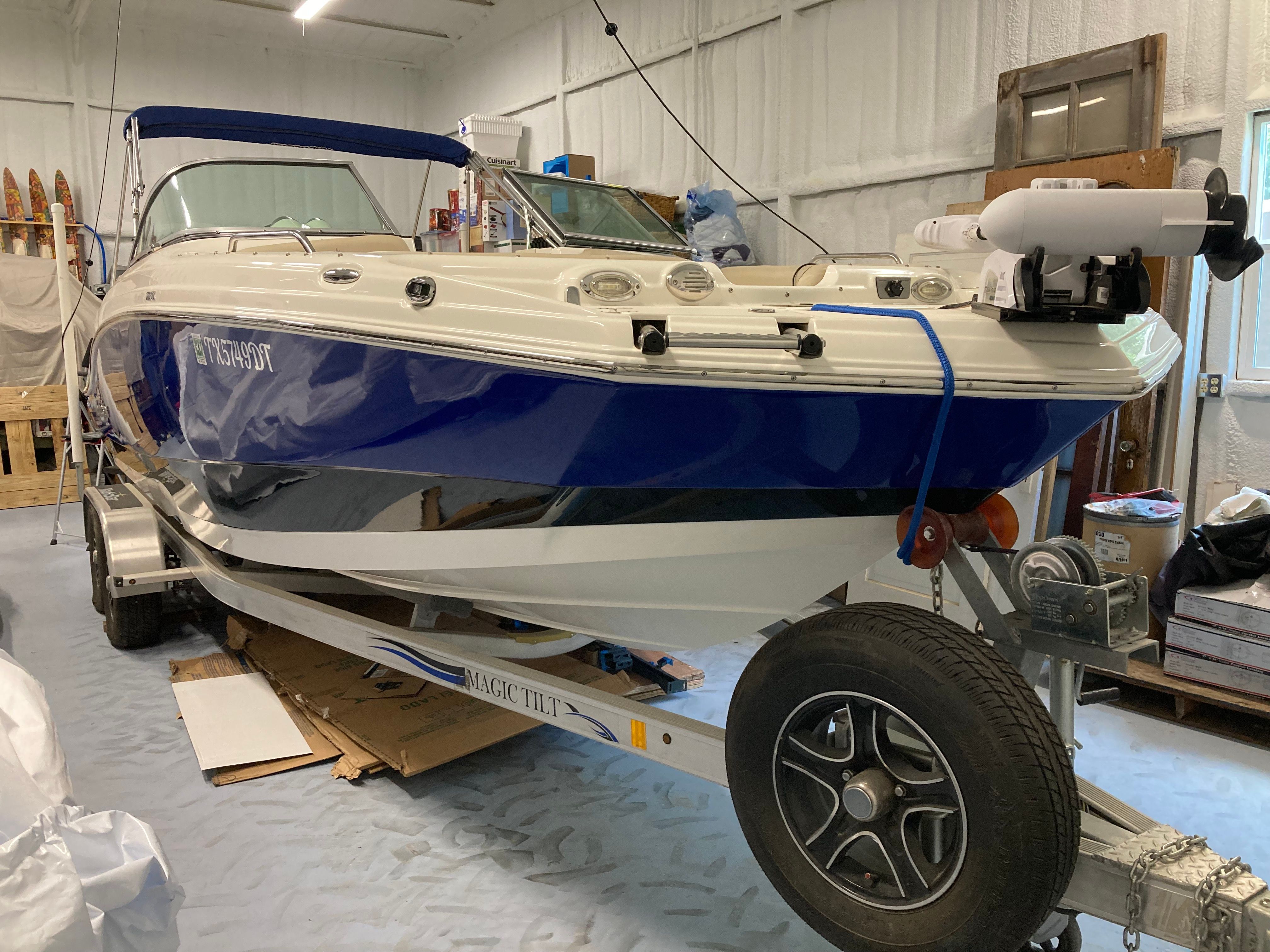 A 2016 Custom 223 DC boat on a trailer in a storage facility.
